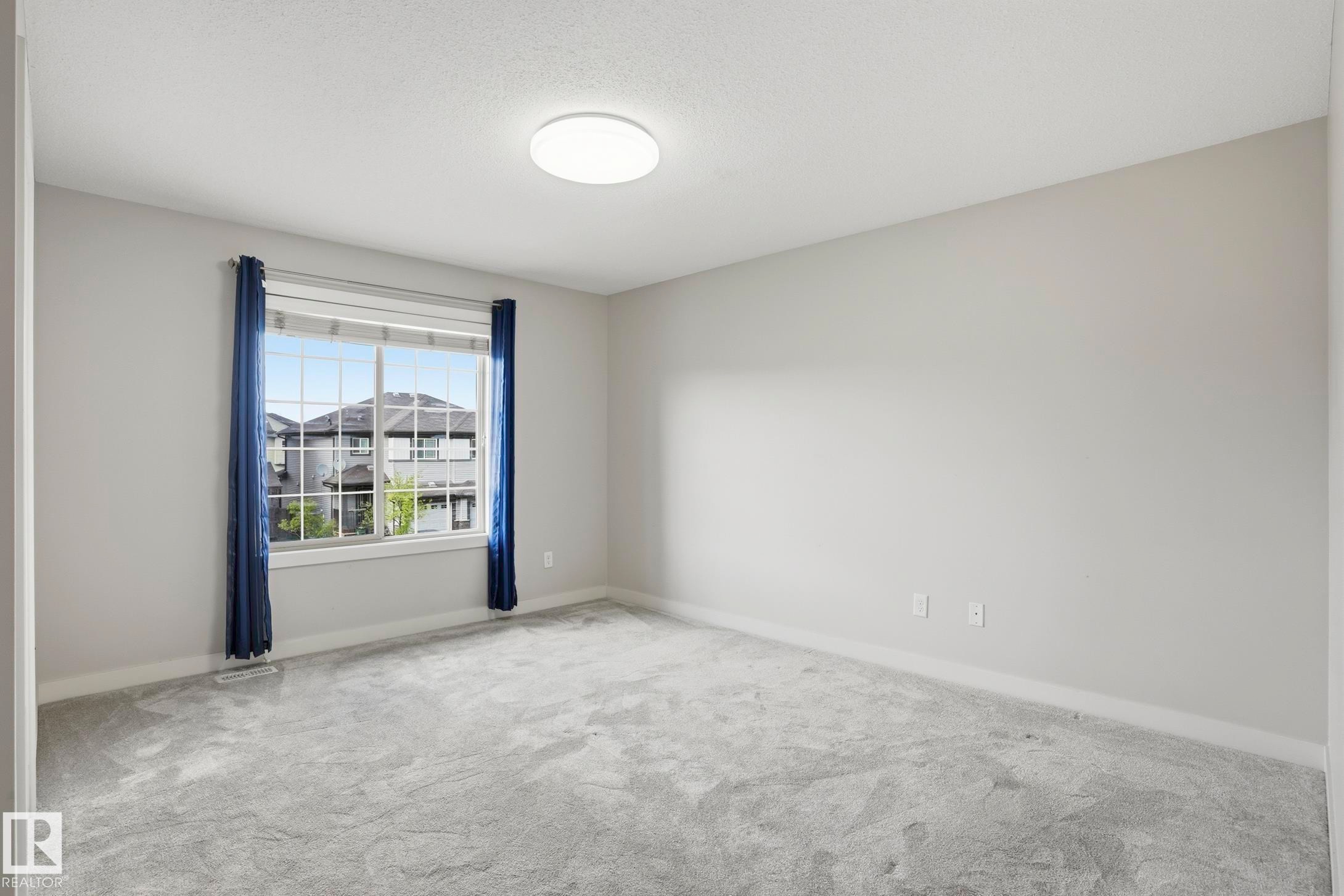 Light gray wall paint complemented by matching gray carpeting - 2917 16A Avenue, Edmonton, AB - Indoor Photo Showing Other Room