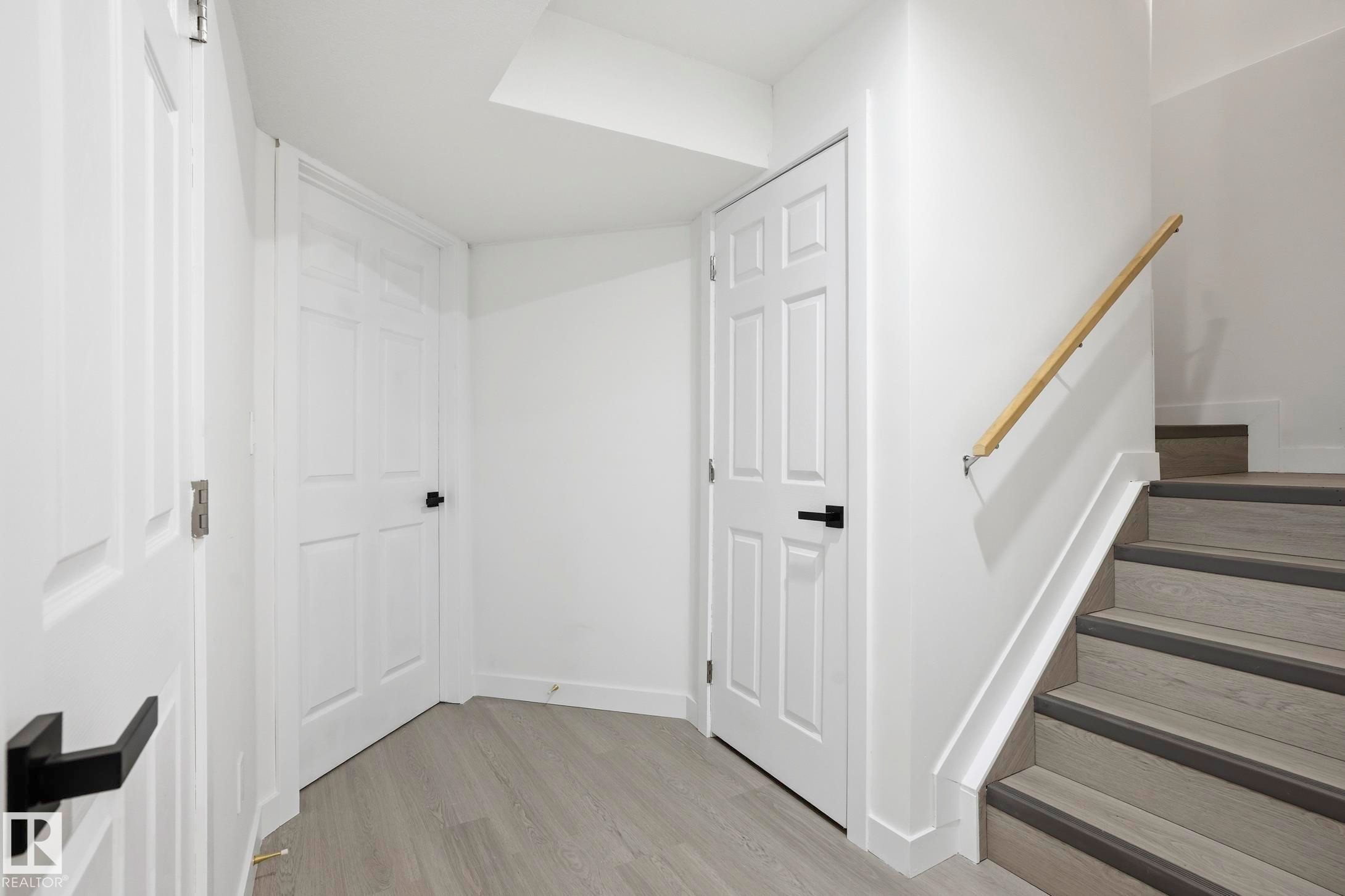 Staircase featuring wood-finish treads with dark risers and a light wood handrail - 2917 16A Avenue, Edmonton, AB - Indoor Photo Showing Other Room