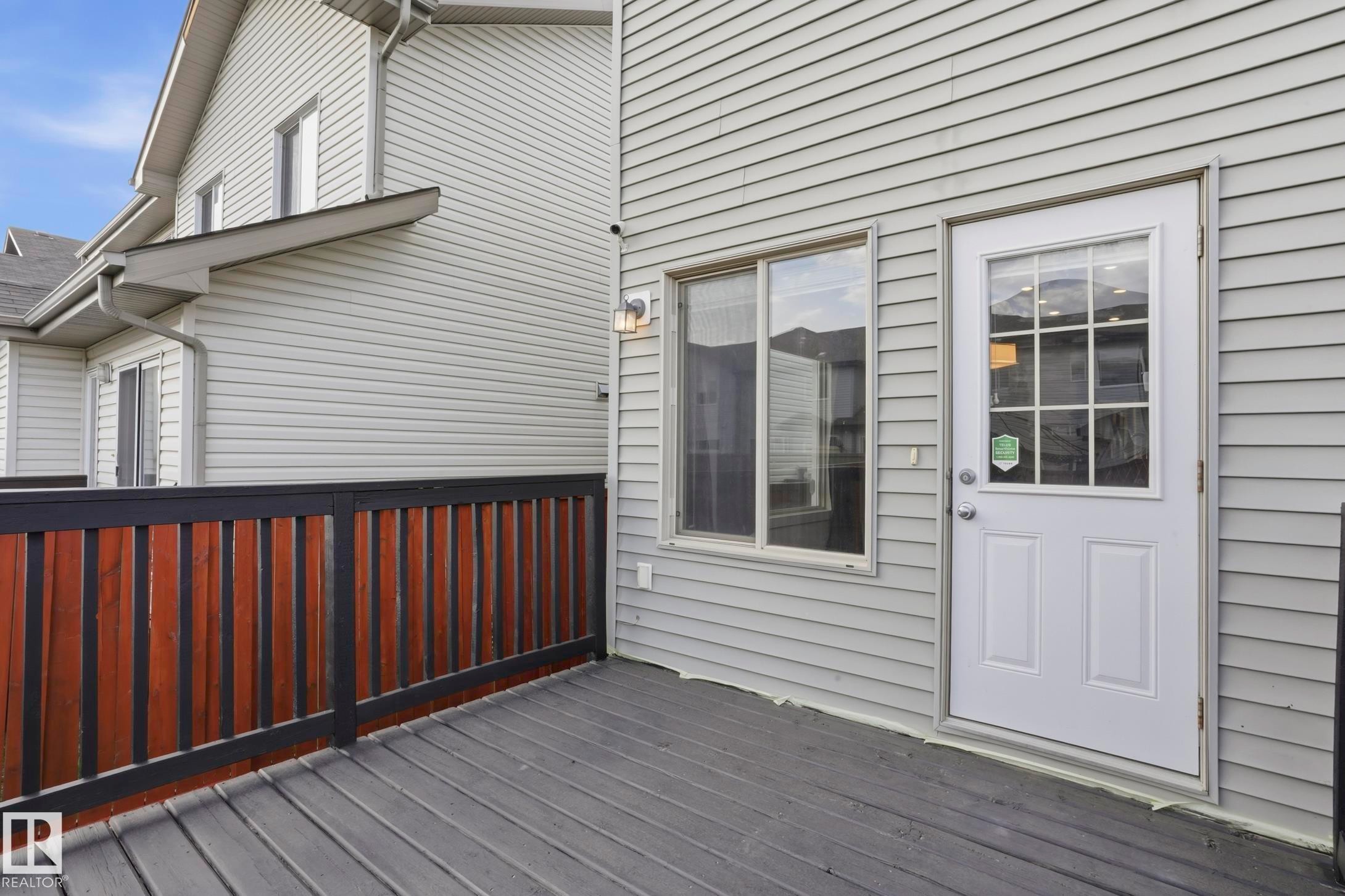 Expansive outdoor deck featuring composite decking, a two-tone privacy fence, and direct exterior access - 2917 16A Avenue, Edmonton, AB - Outdoor With Exterior