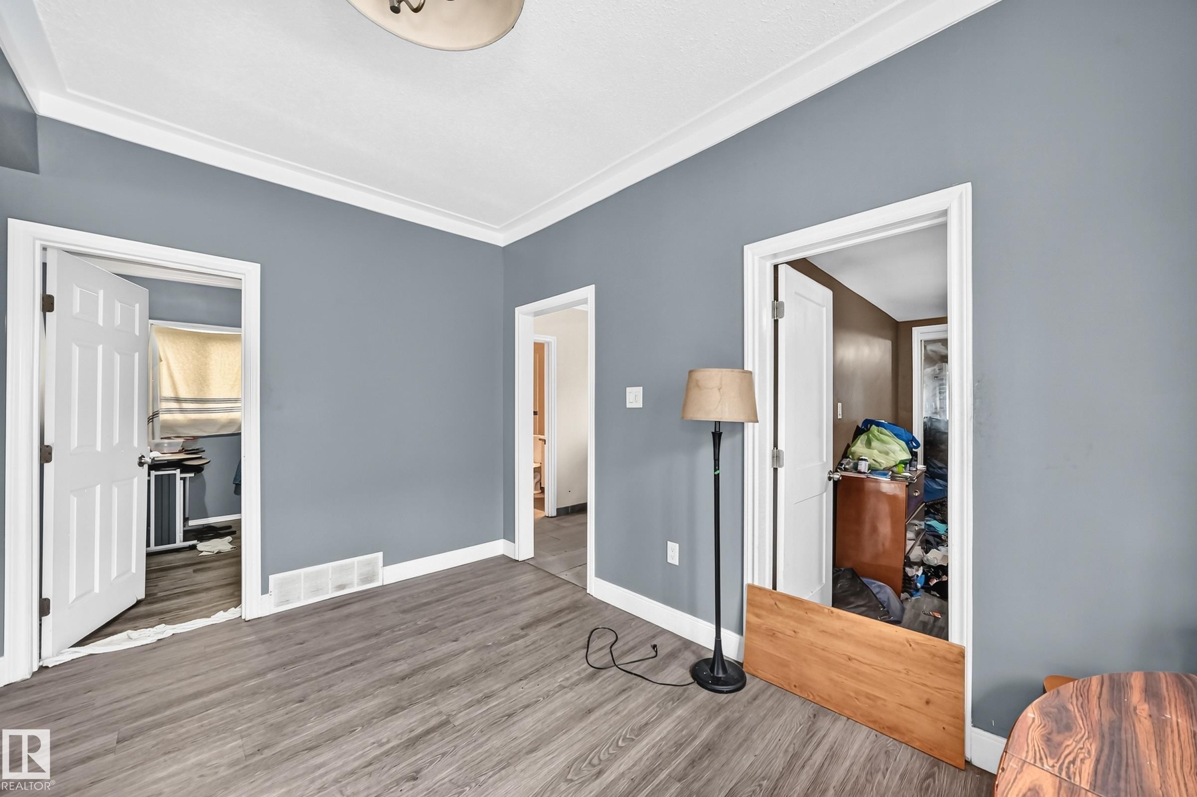 Wood-finish flooring, crown molding, and trim accents - 12627 71 Street Nw, Edmonton, AB
