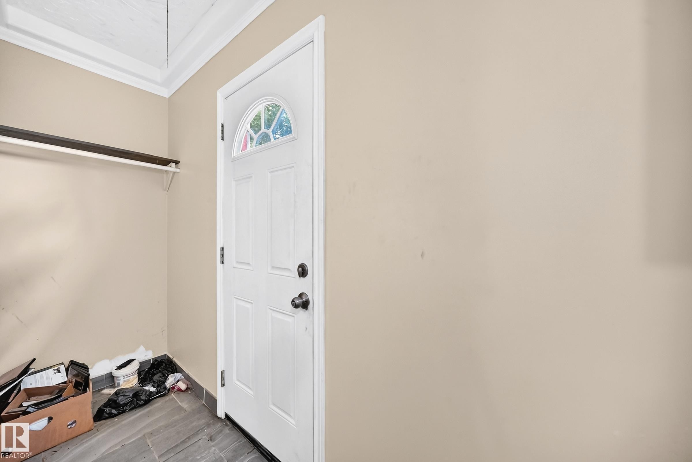 White door with an arched window, tile flooring, and a wall-mounted shelf - 12627 71 Street Nw, Edmonton, AB