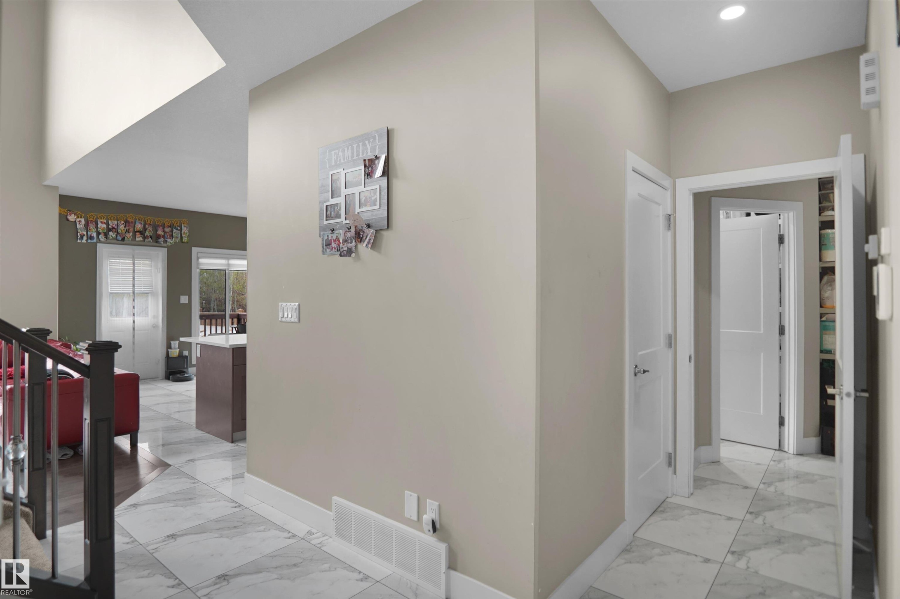 Foyer featuring large-format marble-look floor tiles, white trim, and a high ceiling - 6108 173 Ave, Edmonton, AB - Indoor Photo Showing Other Room