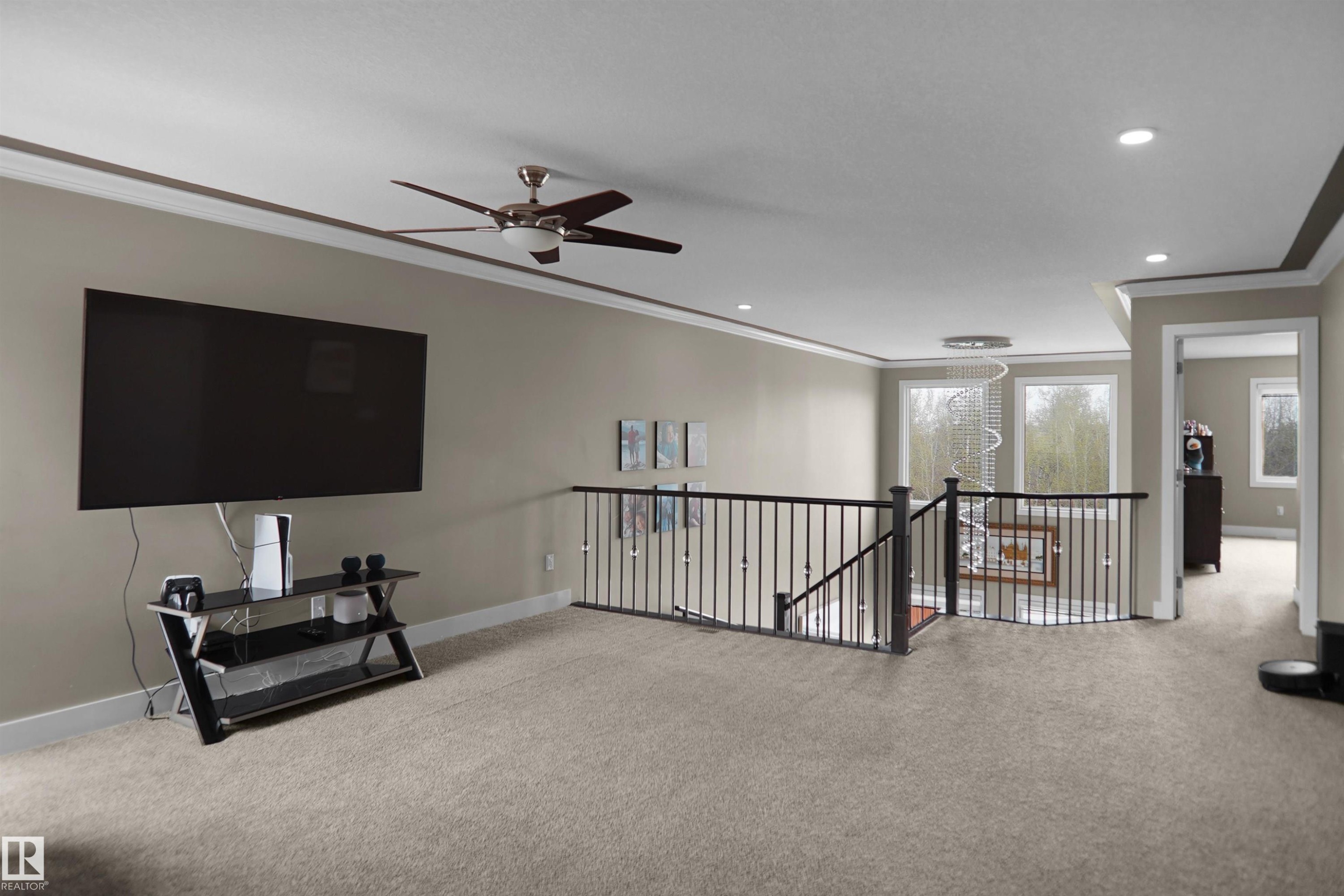 Carpeted upper-level space featuring a contemporary ceiling fan, recessed lighting, and crown molding - 6108 173 Ave, Edmonton, AB - Indoor Photo Showing Other Room