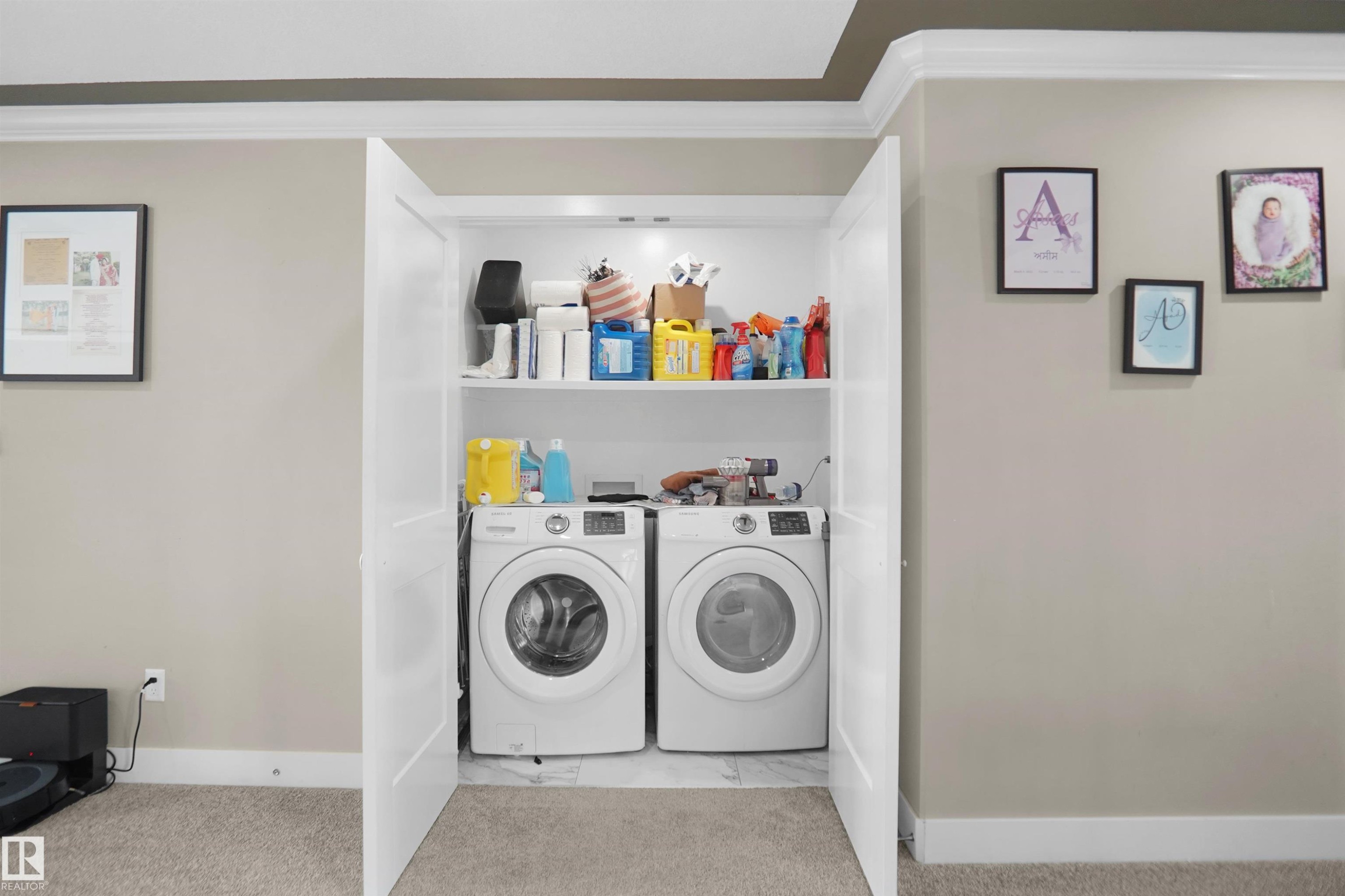 Dedicated laundry closet featuring a stacked shelf system, bi-fold doors, and a carpeted floor - 6108 173 Ave, Edmonton, AB - Indoor Photo Showing Laundry Room