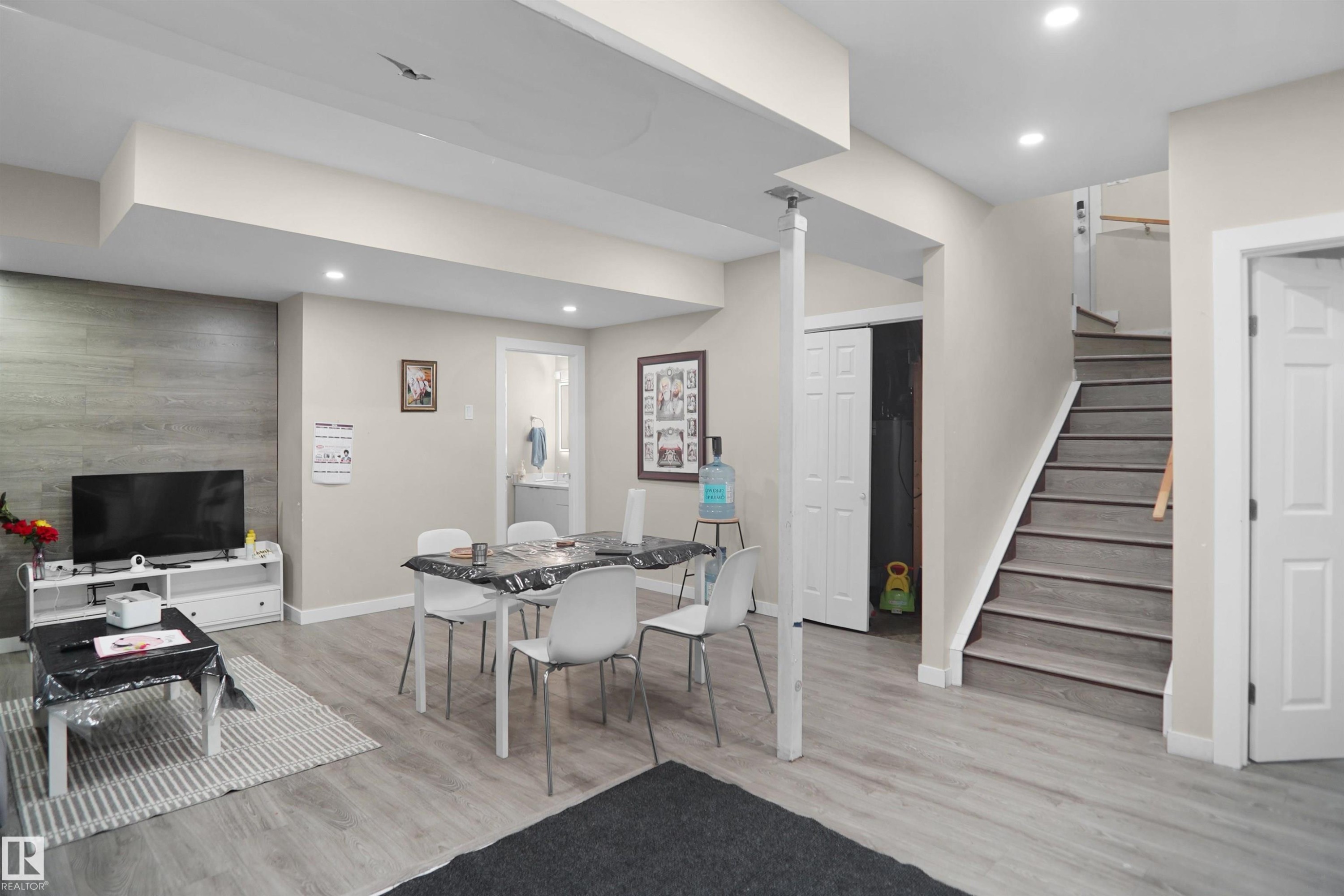 Finished lower level featuring recessed lighting, light-toned walls, wood-finish flooring, and a textured accent wall - 6108 173 Ave, Edmonton, AB - Indoor