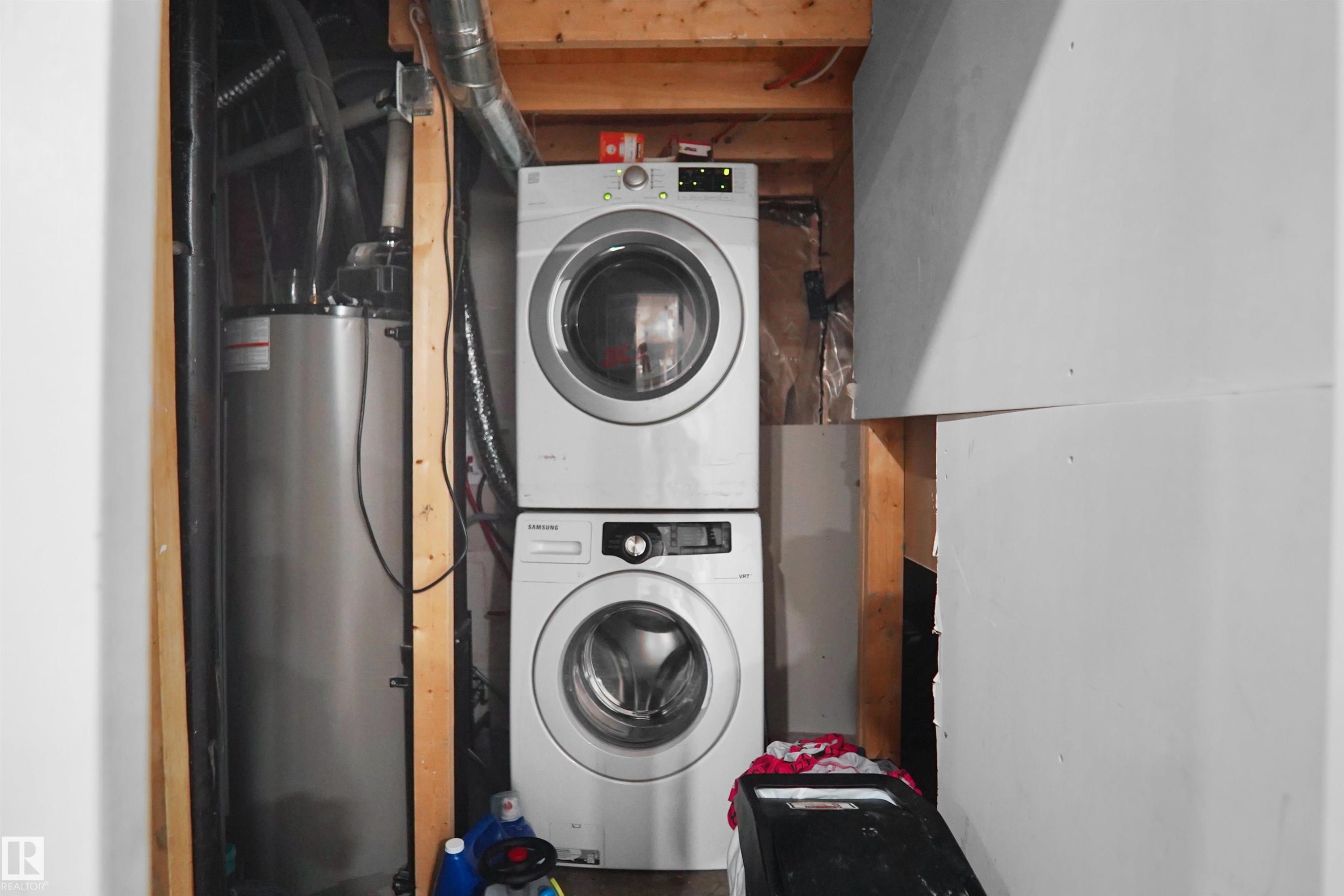 Dedicated utility space featuring a stacked washer and dryer - 6108 173 Ave, Edmonton, AB - Indoor Photo Showing Laundry Room