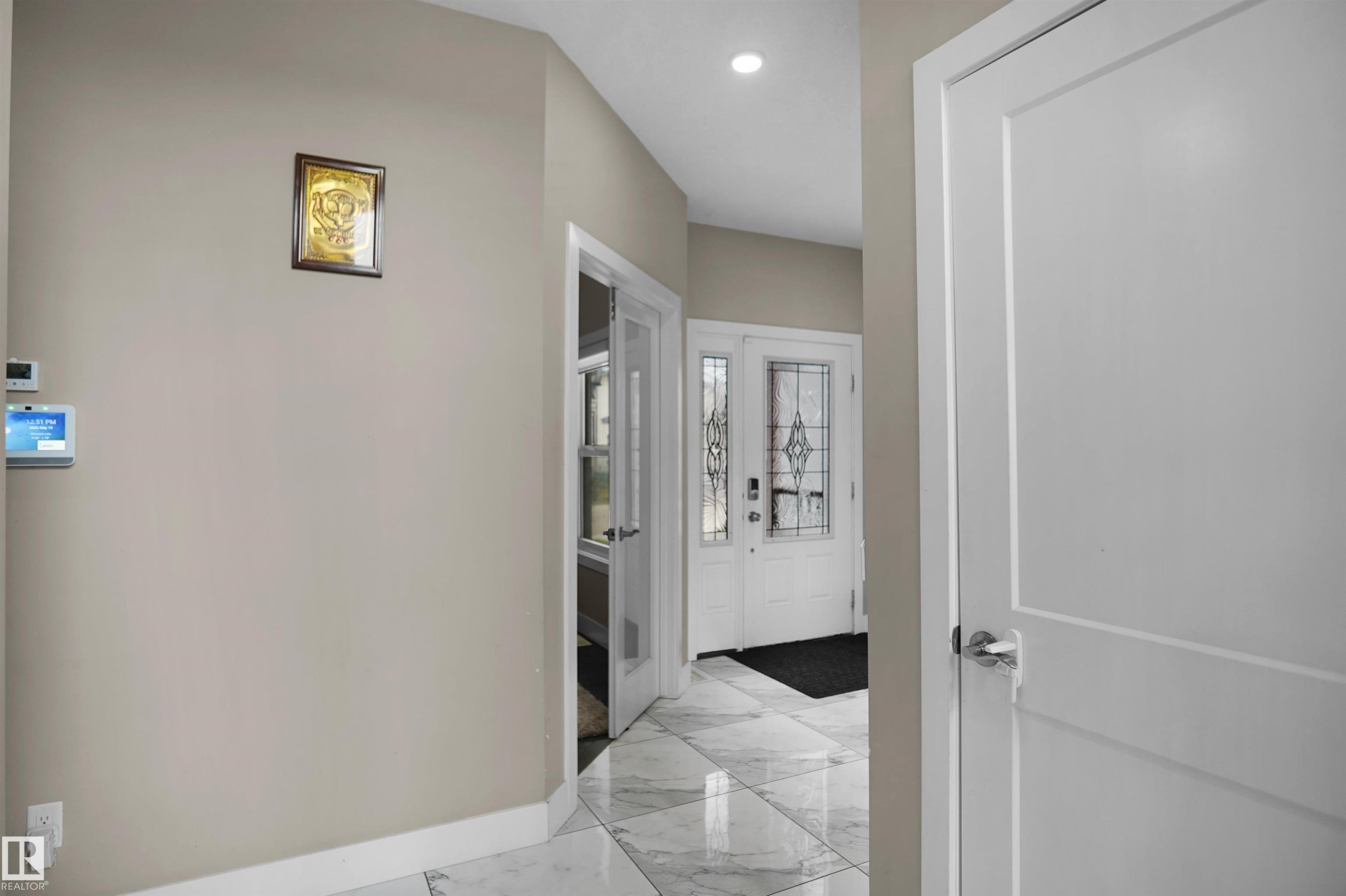 Entryway featuring large format tiled flooring, a modern front door with decorative glass inserts, and a recessed ceiling light - 6108 173 Ave, Edmonton, AB - Indoor Photo Showing Other Room