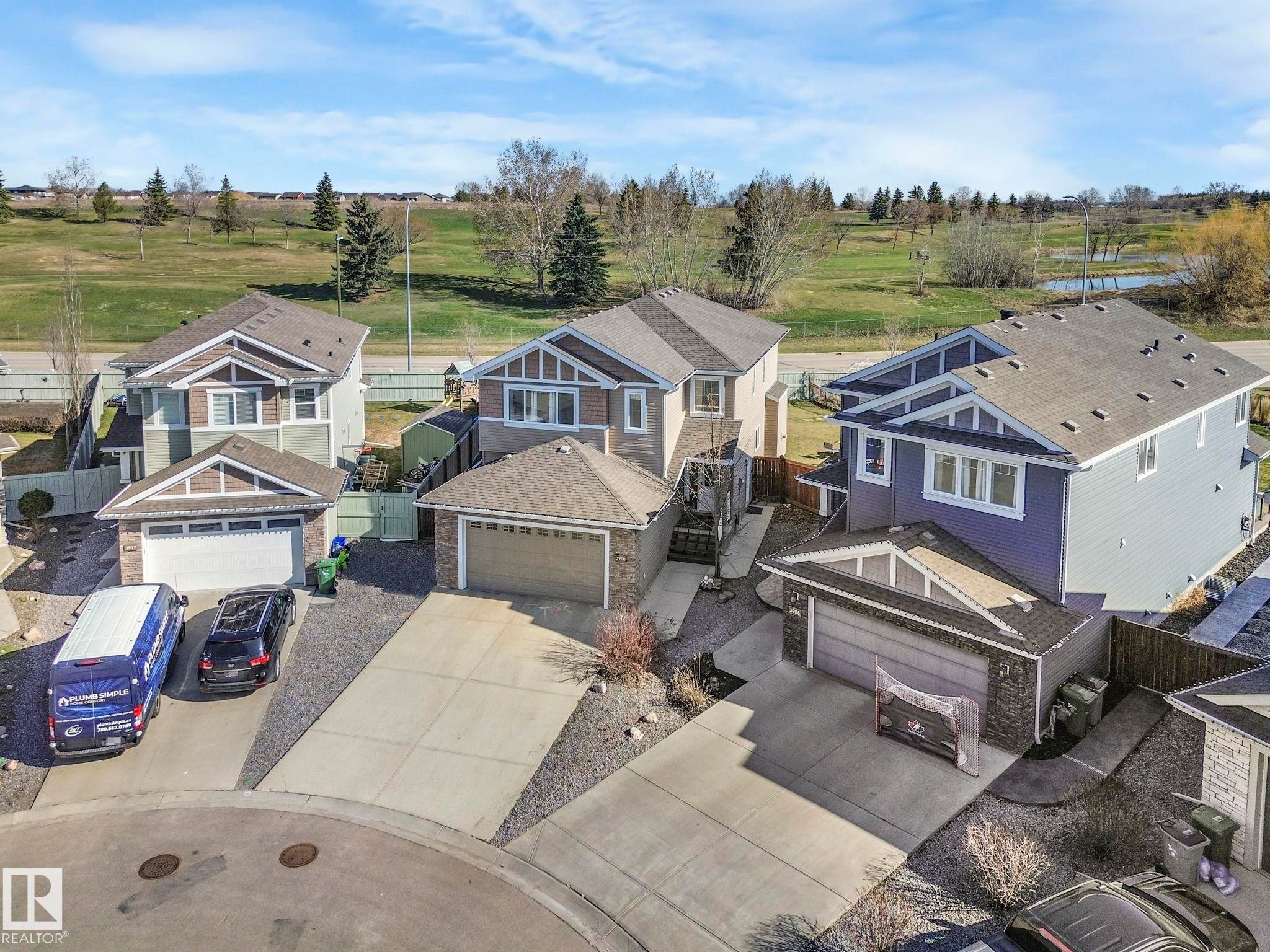 Contemporary residential properties featuring multi-toned siding, attached garages, and paved driveways - 3910 49 Avenue, Beaumont, AB - Outdoor