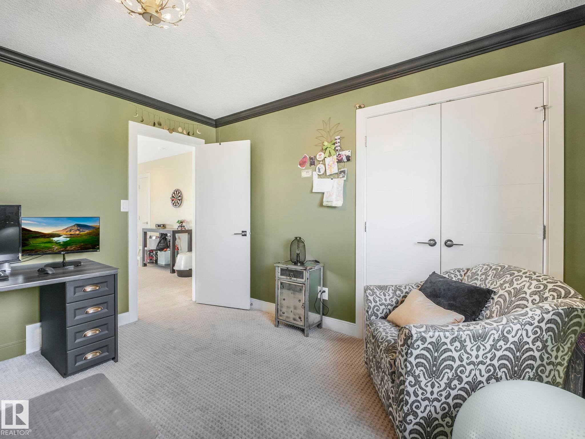 Light gray carpeted flooring paired with olive-toned walls - 3910 49 Avenue, Beaumont, AB - Indoor Photo Showing Bedroom