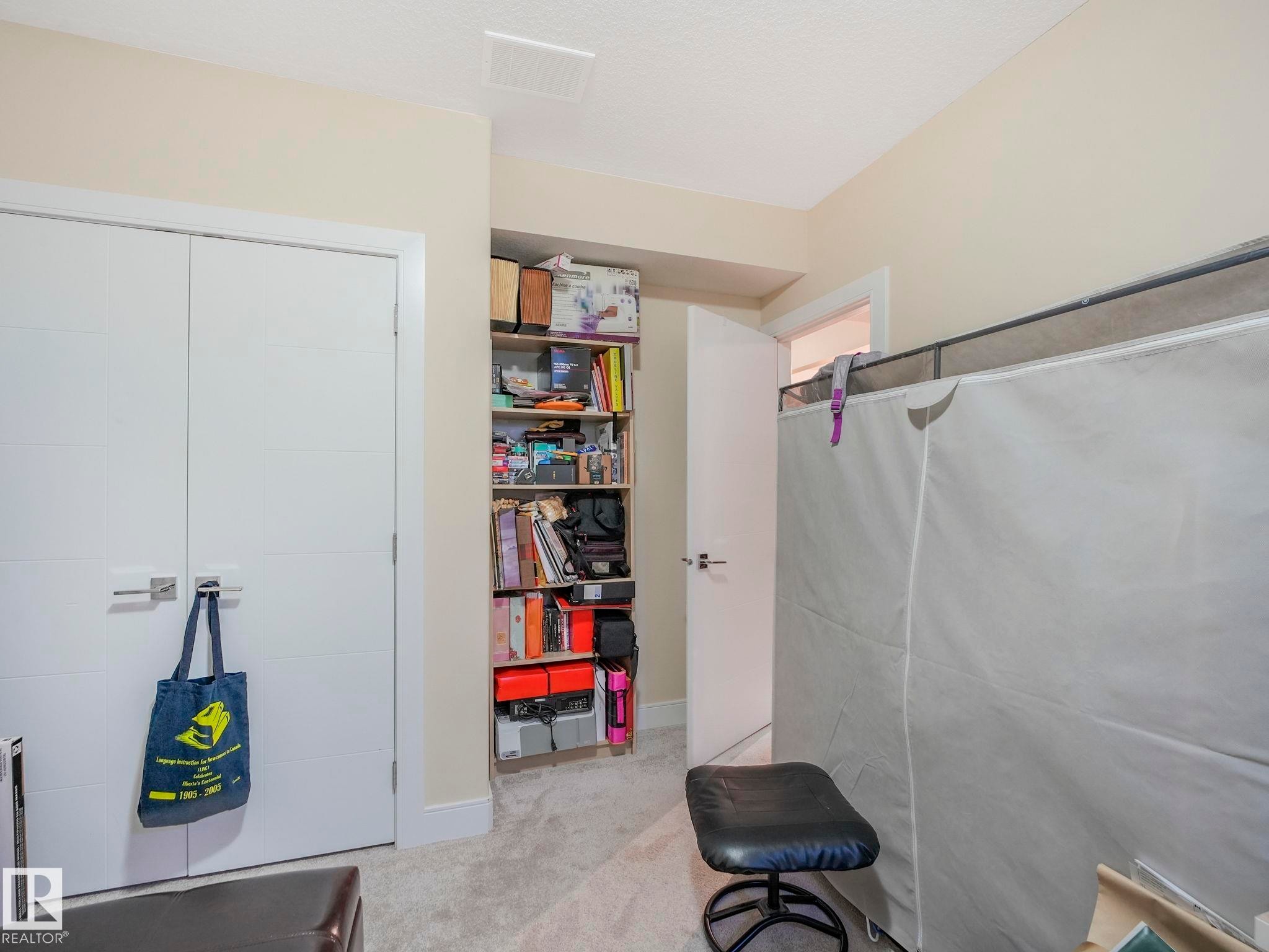 Light-toned carpeting complements the neutral wall color in this interior space - 3910 49 Avenue, Beaumont, AB - Indoor Photo Showing Other Room