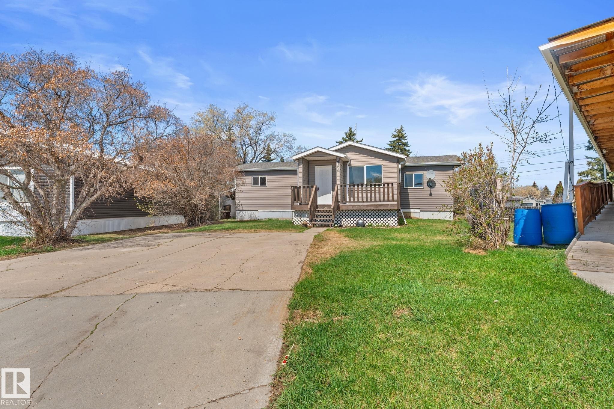 Single-story residence featuring brown siding with white trim - 4508 50A Avenue, Barrhead, AB - Outdoor