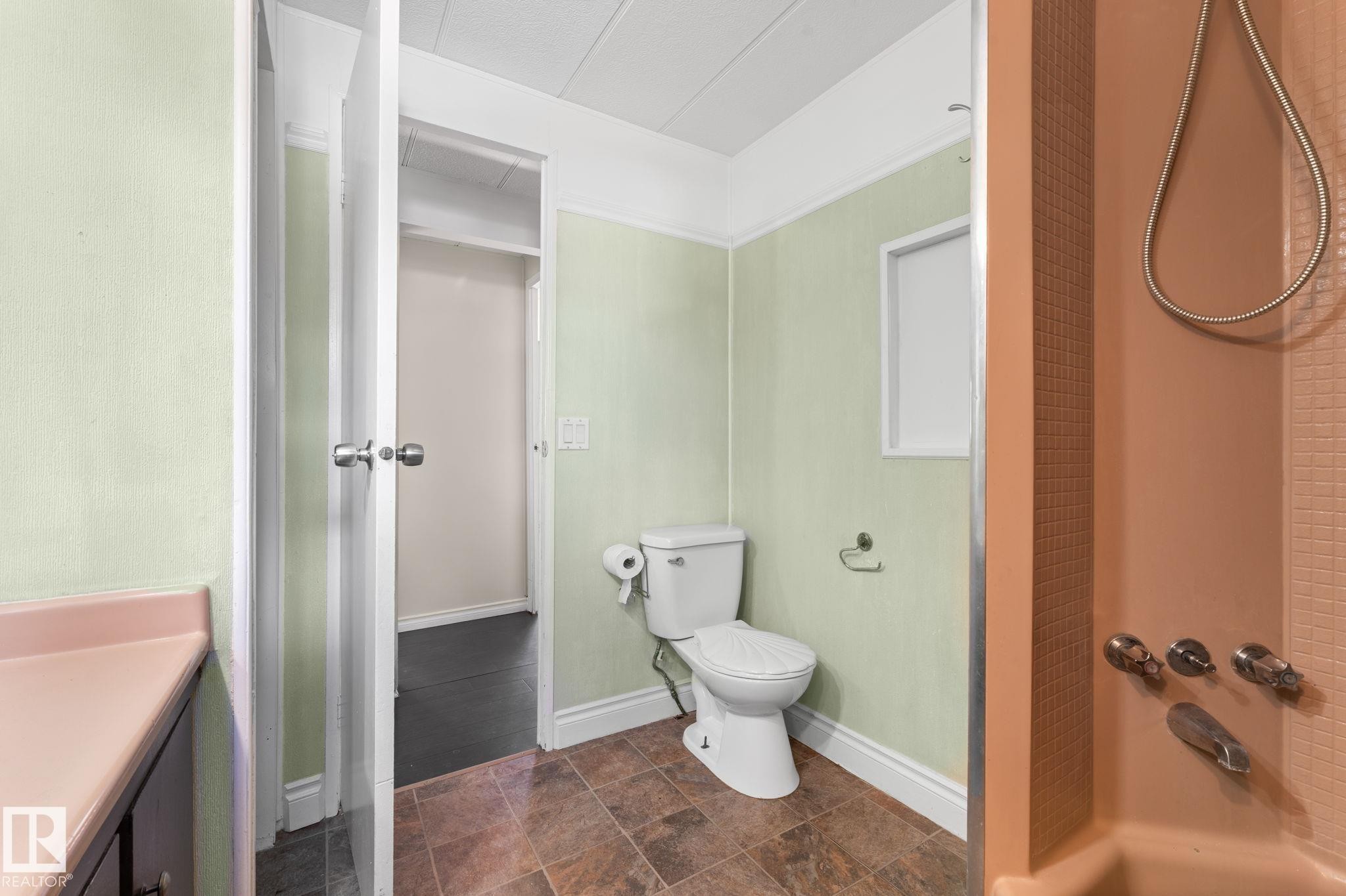 Bathroom featuring a toilet, tile flooring, and a shower area with tiled walls - 4508 50A Avenue, Barrhead, AB - Indoor Photo Showing Bathroom