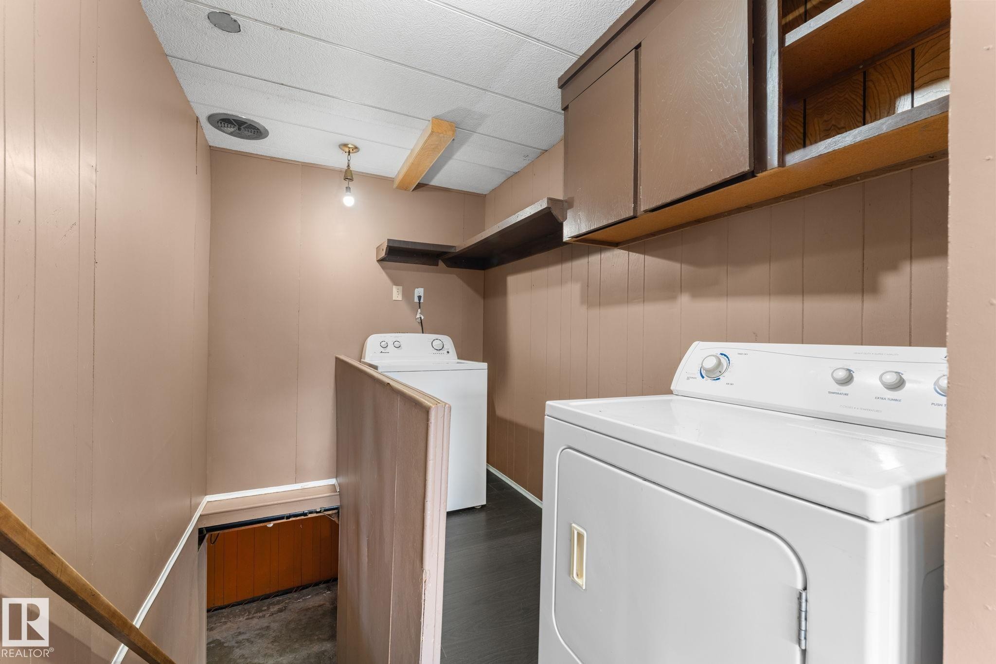 Dedicated laundry area featuring a white top-loading washing machine and dryer - 4508 50A Avenue, Barrhead, AB - Indoor Photo Showing Laundry Room