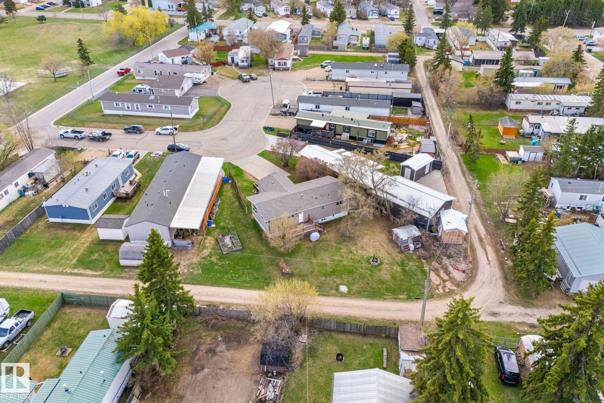Aerial perspective showcasing a residential area with a mix of single-story and multi-story structures - 4508 50A Avenue, Barrhead, AB - Outdoor With View