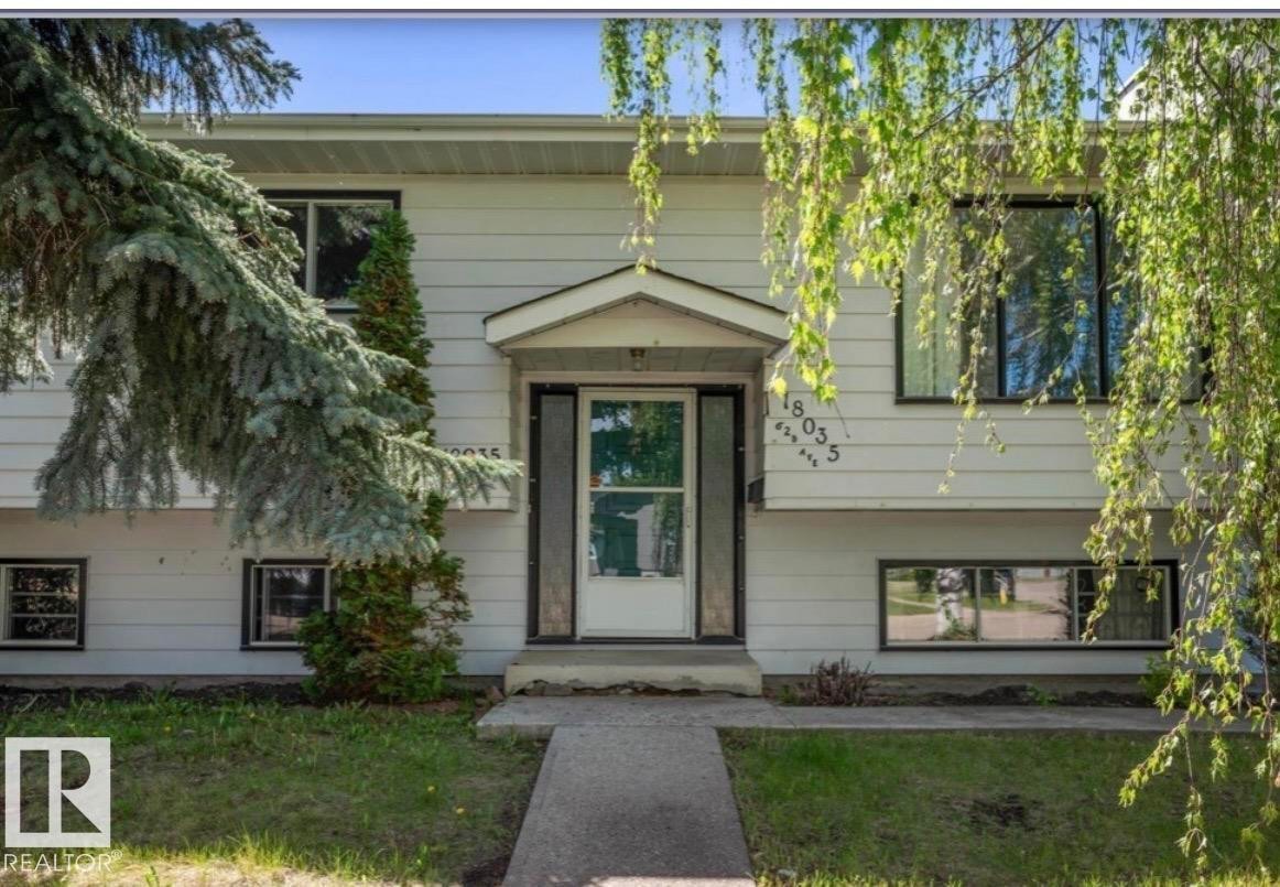Front exterior with white siding and dark trim windows - 18035 62B Avenue, Edmonton, AB - Outdoor