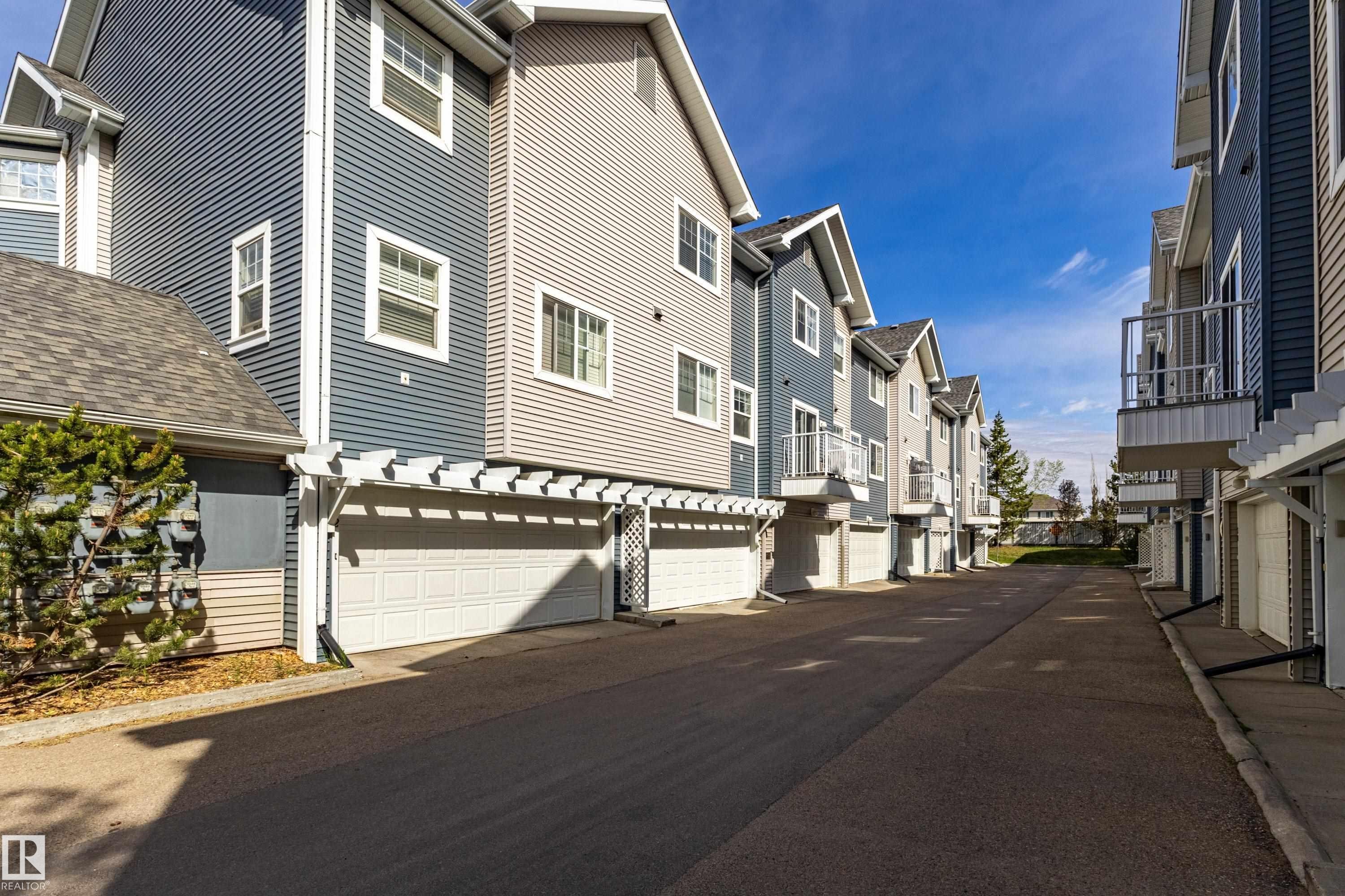 Contemporary townhome exteriors featuring horizontal siding in varied blue and gray tones - 41 8304 11 Avenue, Edmonton, AB - Outdoor