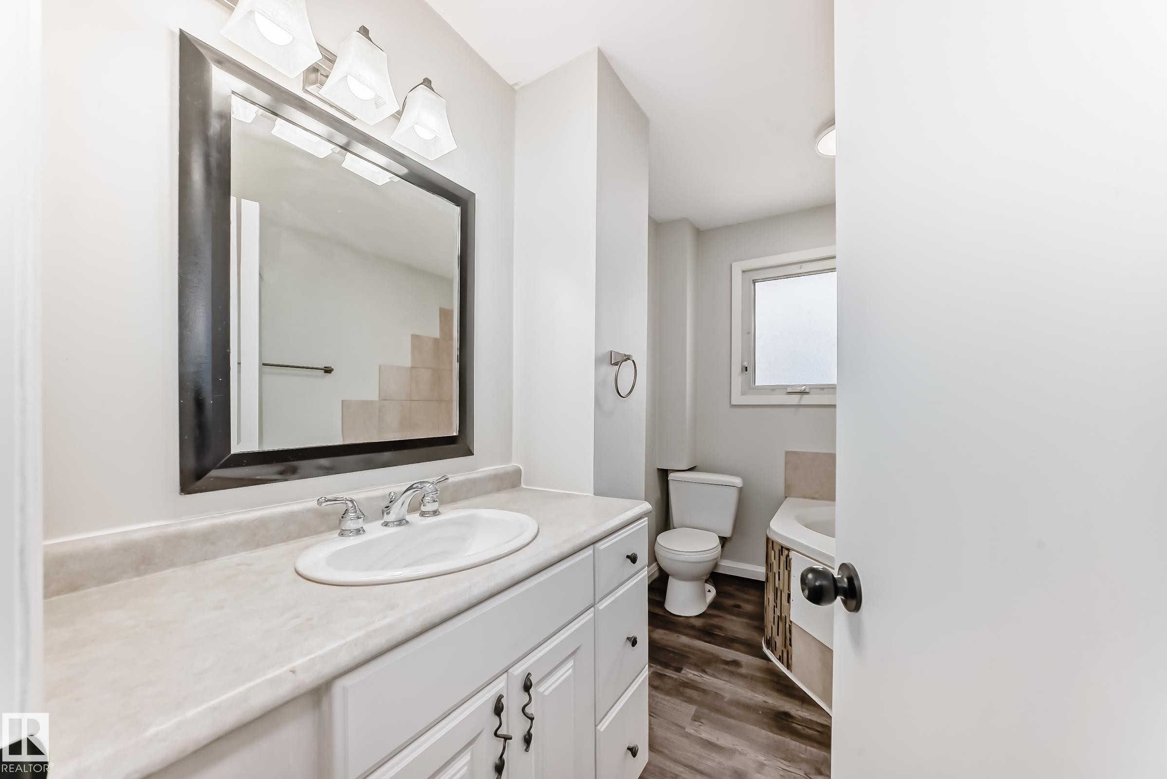 Bathroom vanity with a white countertop and undermount sink - 8615 42A Avenue, Edmonton, AB - Indoor Photo Showing Bathroom