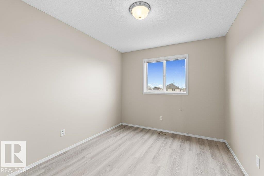 Bright interior space featuring light wood-finish flooring and a neutral wall palette - 21344 88 Avenue, Edmonton, AB - Indoor Photo Showing Other Room