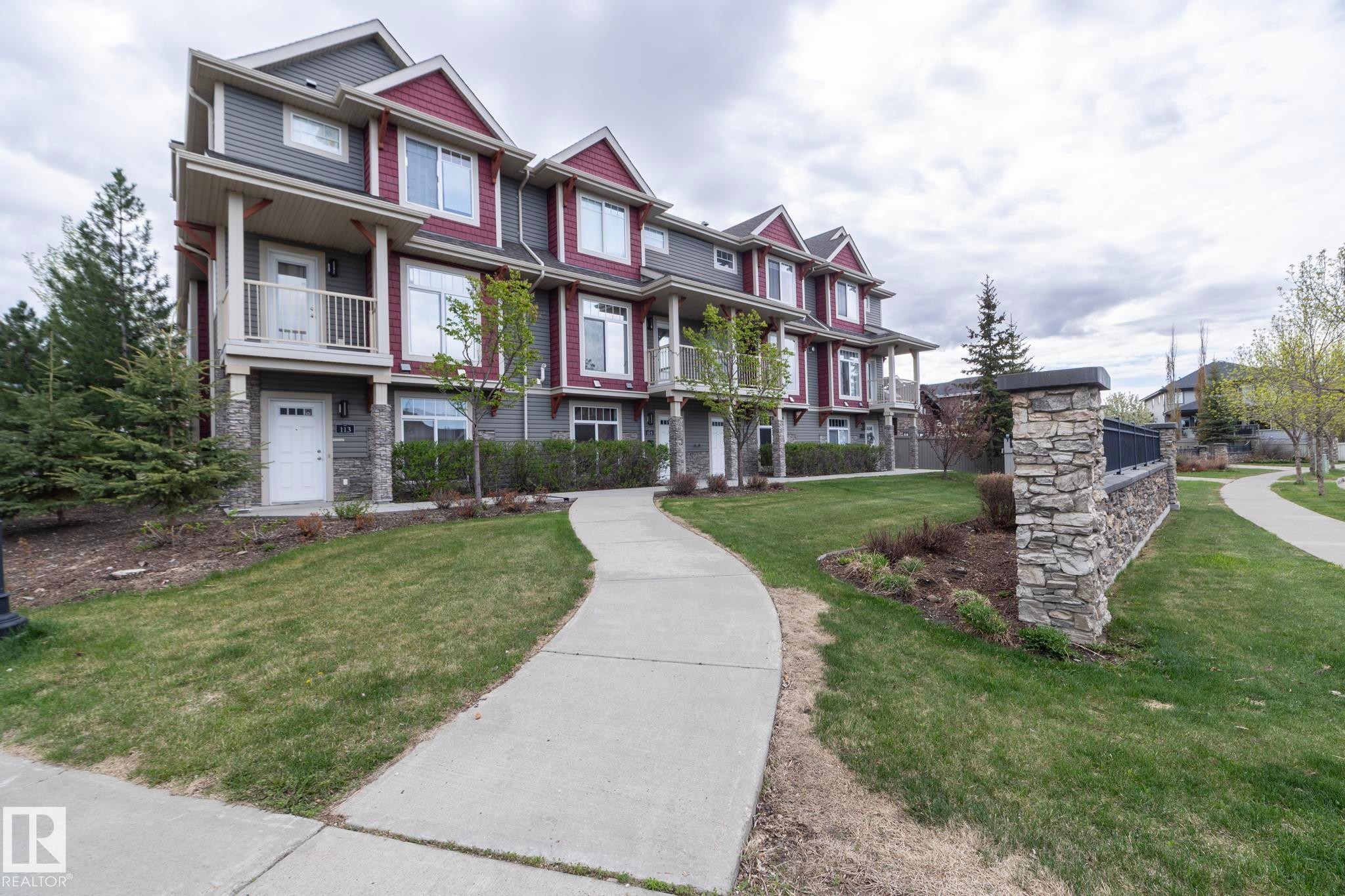 Contemporary multi-story townhome with a distinctive red and gray exterior - 117 Callaghan Drive Sw, Edmonton, AB - Outdoor With Facade