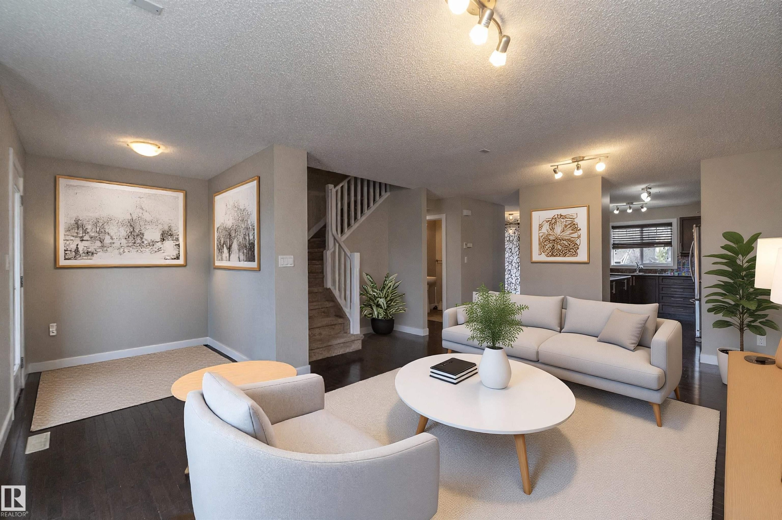 Open-concept living space featuring dark wood-finish flooring, light neutral wall tones, and recessed lighting - 117 Callaghan Drive Sw, Edmonton, AB - Indoor Photo Showing Living Room