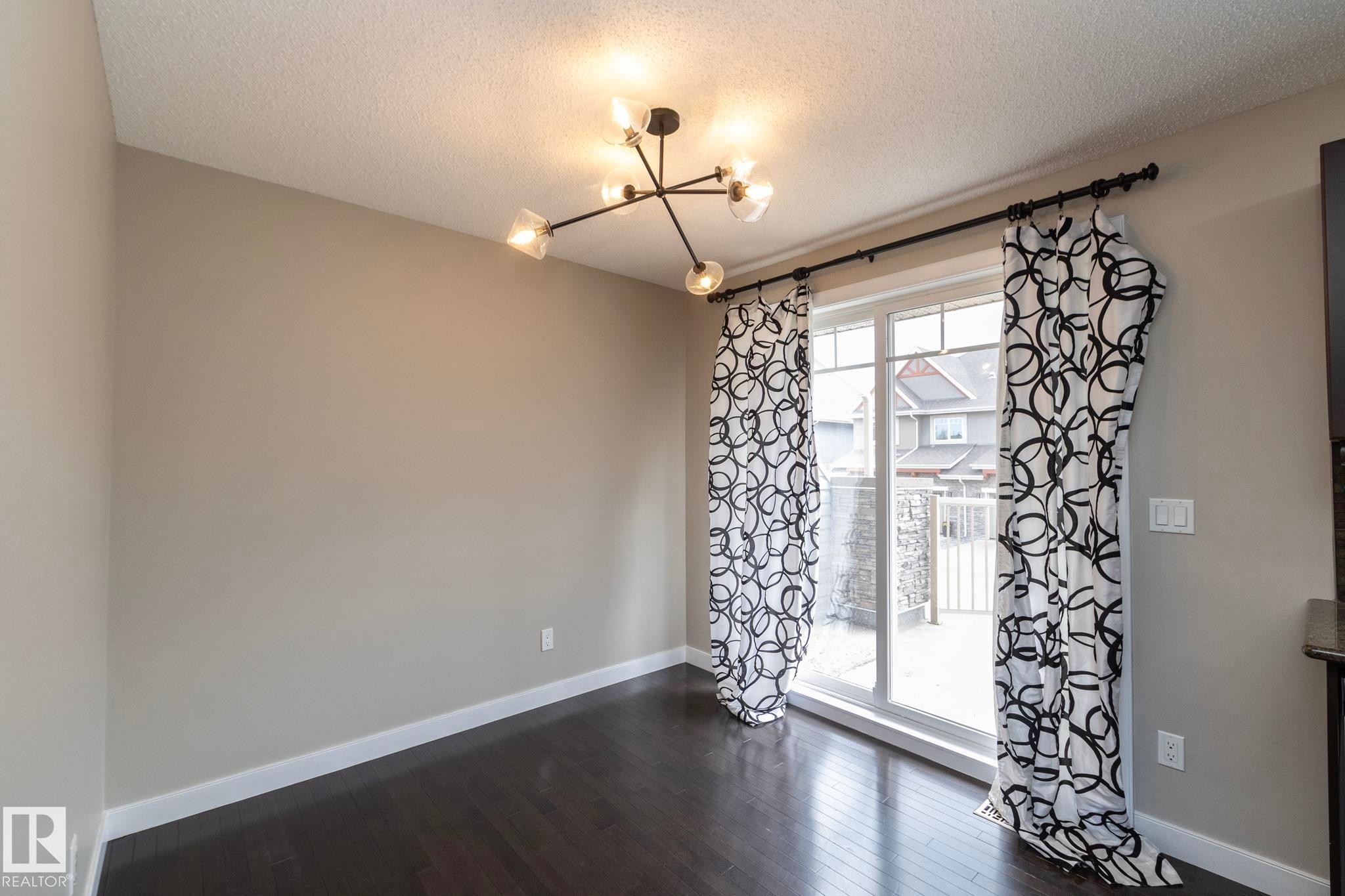 Sliding glass door providing exterior access - 117 Callaghan Drive Sw, Edmonton, AB - Indoor Photo Showing Other Room