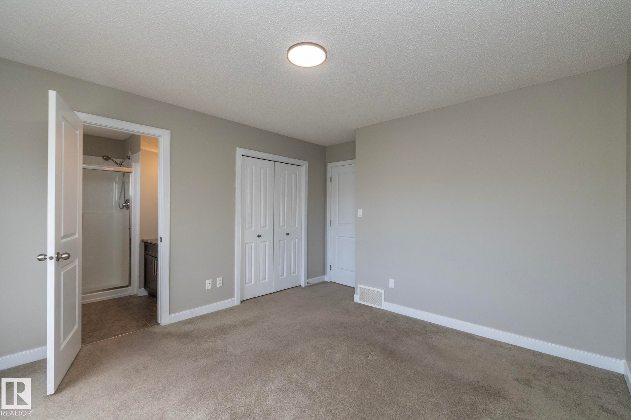 Bedroom featuring neutral-toned carpeting, light gray walls, and white trim - 117 Callaghan Drive Sw, Edmonton, AB - Indoor Photo Showing Other Room