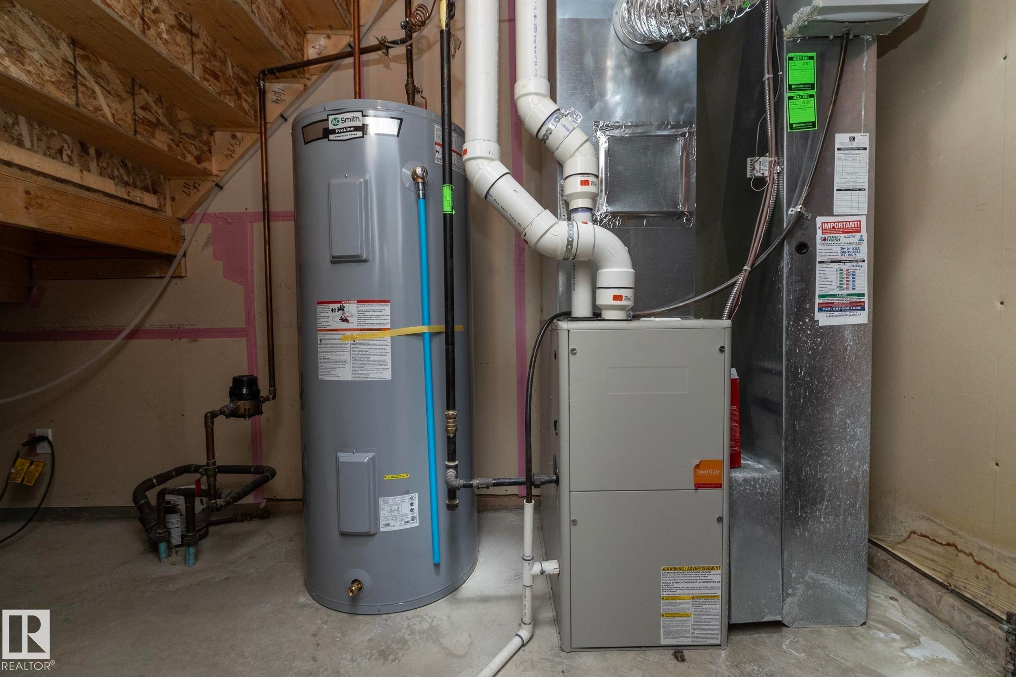 Mechanical room featuring a water heater, furnace, and exposed ductwork - 117 Callaghan Drive Sw, Edmonton, AB - Indoor Photo Showing Basement