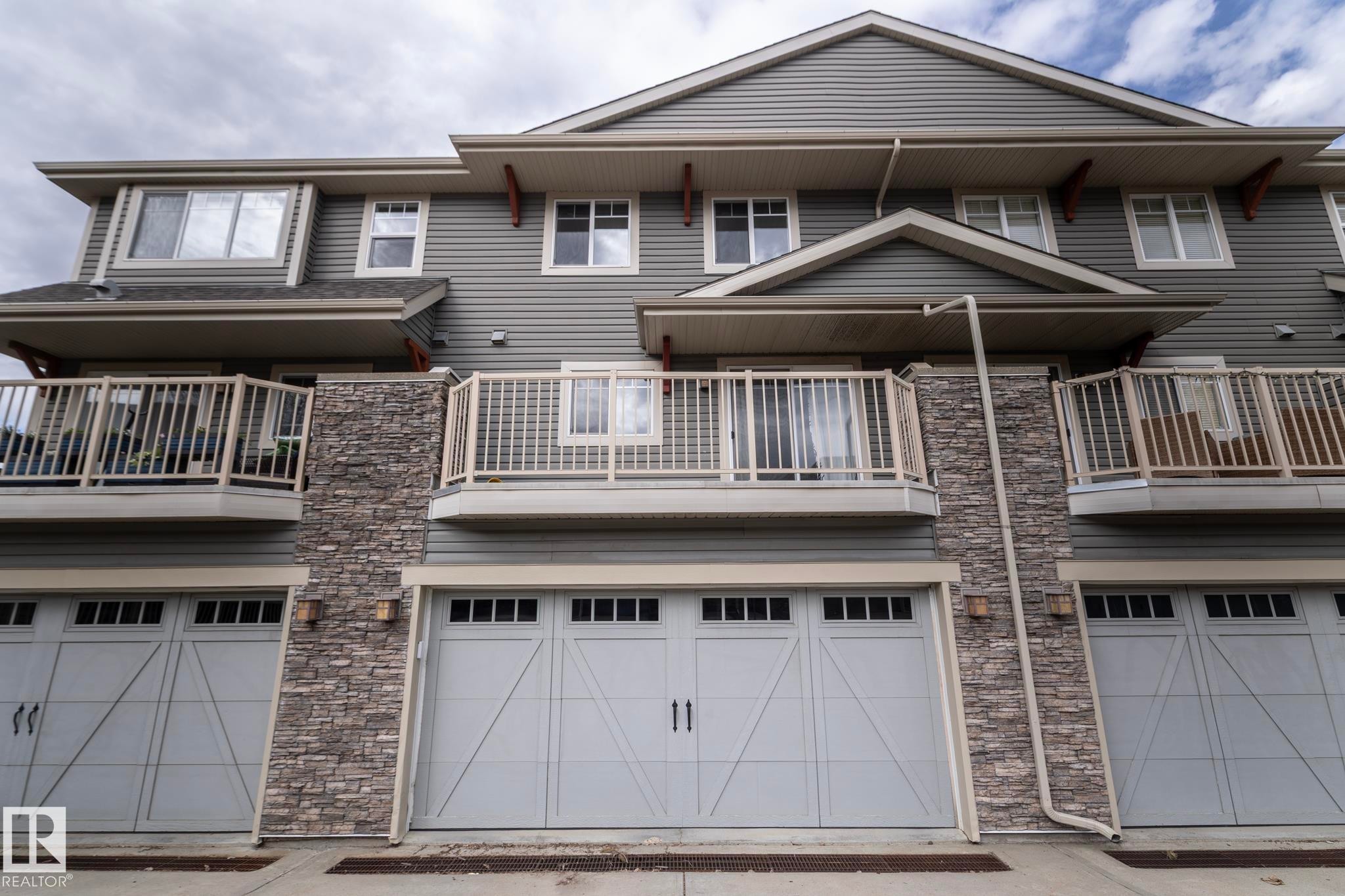 Multi-level exterior featuring horizontal siding and stone veneer accents - 117 Callaghan Drive Sw, Edmonton, AB - Outdoor