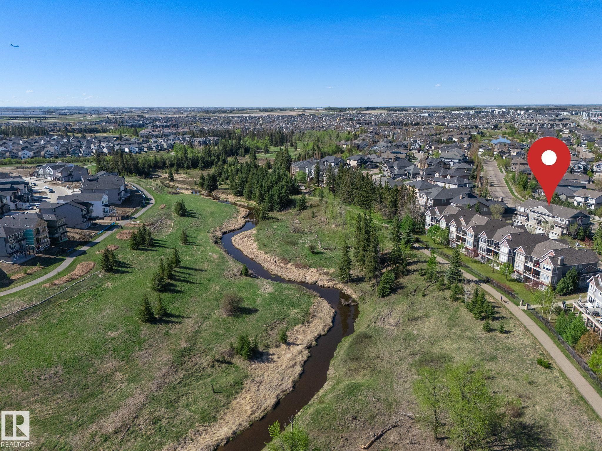 Aerial depiction of a residential area featuring a winding natural watercourse - 117 Callaghan Drive Sw, Edmonton, AB - Outdoor With View