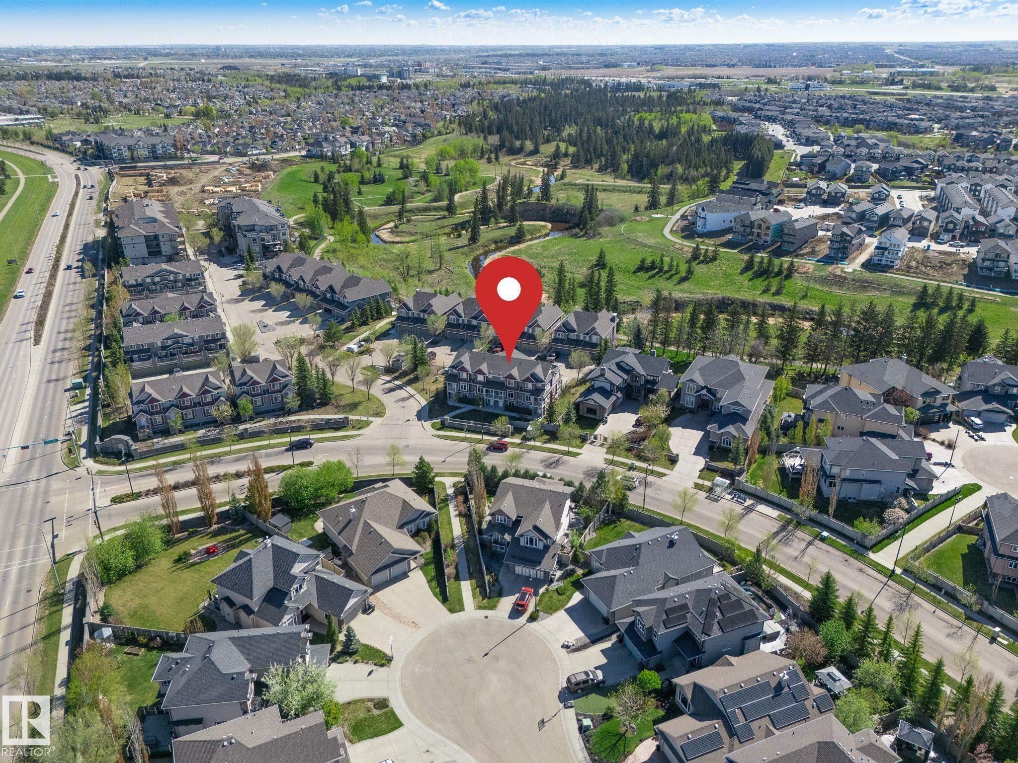 Aerial perspective showcasing a residential development with a golf course backdrop - 117 Callaghan Drive Sw, Edmonton, AB - Outdoor With View