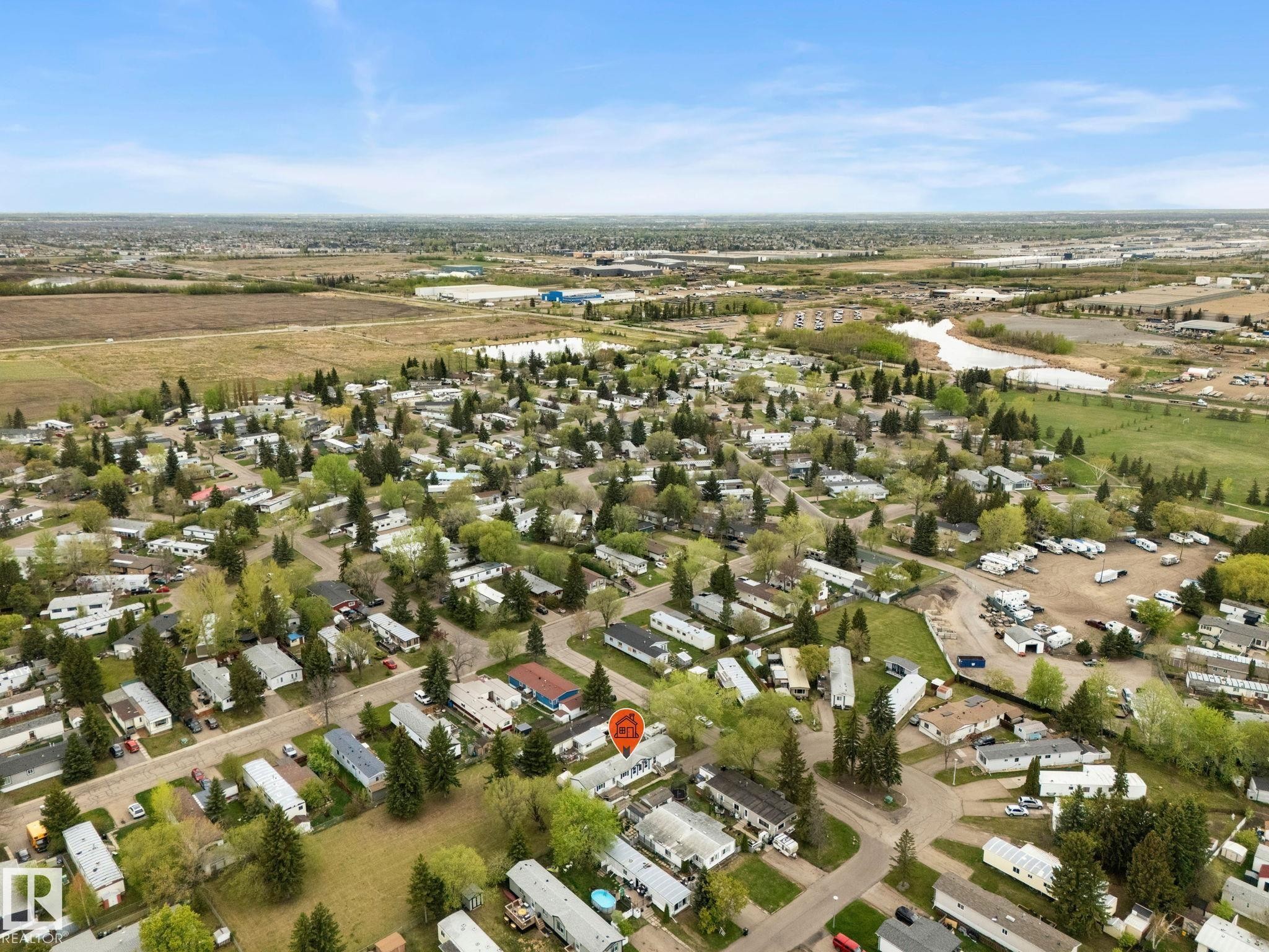 Aerial perspective showcasing a residential community with numerous detached properties and established trees - 49 Rim Road Nw, Edmonton, AB - Outdoor With View