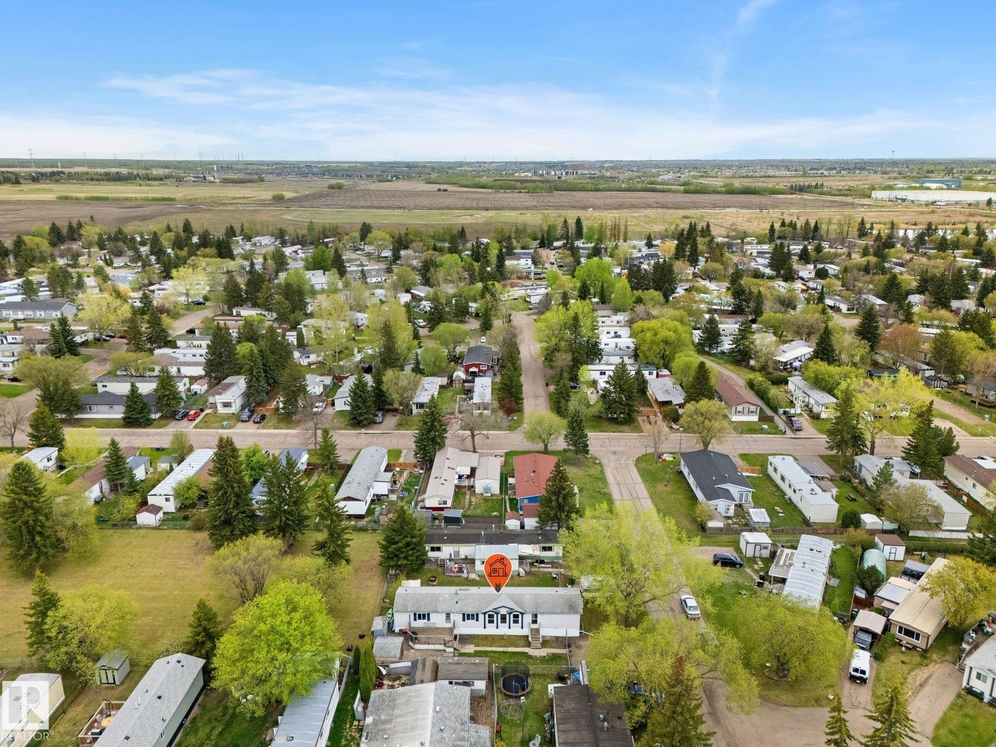 Aerial view of a residential community with numerous detached homes, mature trees, and paved streets - 49 Rim Road Nw, Edmonton, AB - Outdoor With View
