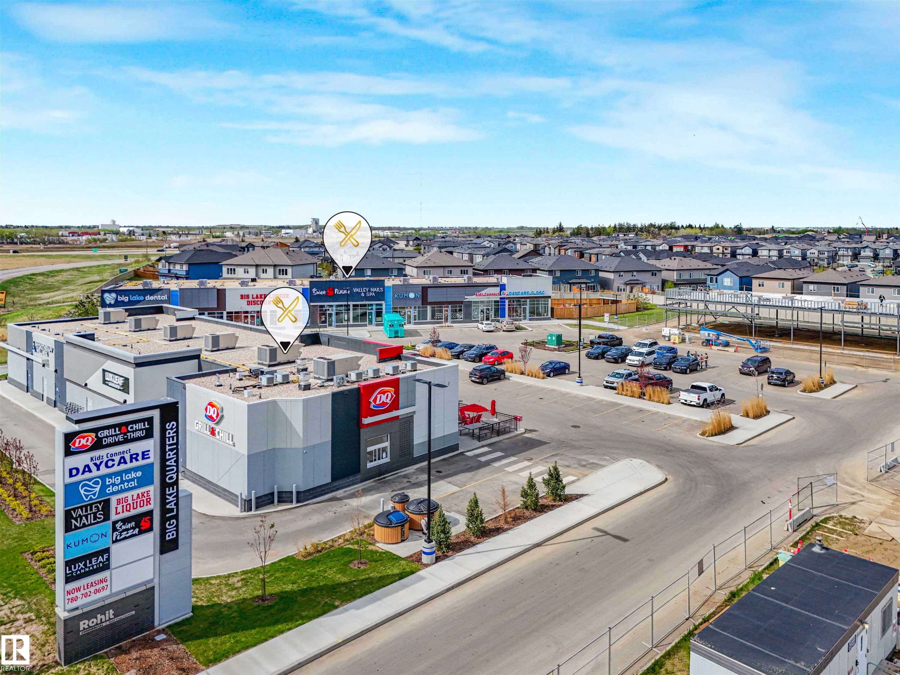 Commercial property featuring multiple retail establishments and a prominent pylon sign - 1518 Siskin Link Link, Edmonton, AB - Outdoor With View
