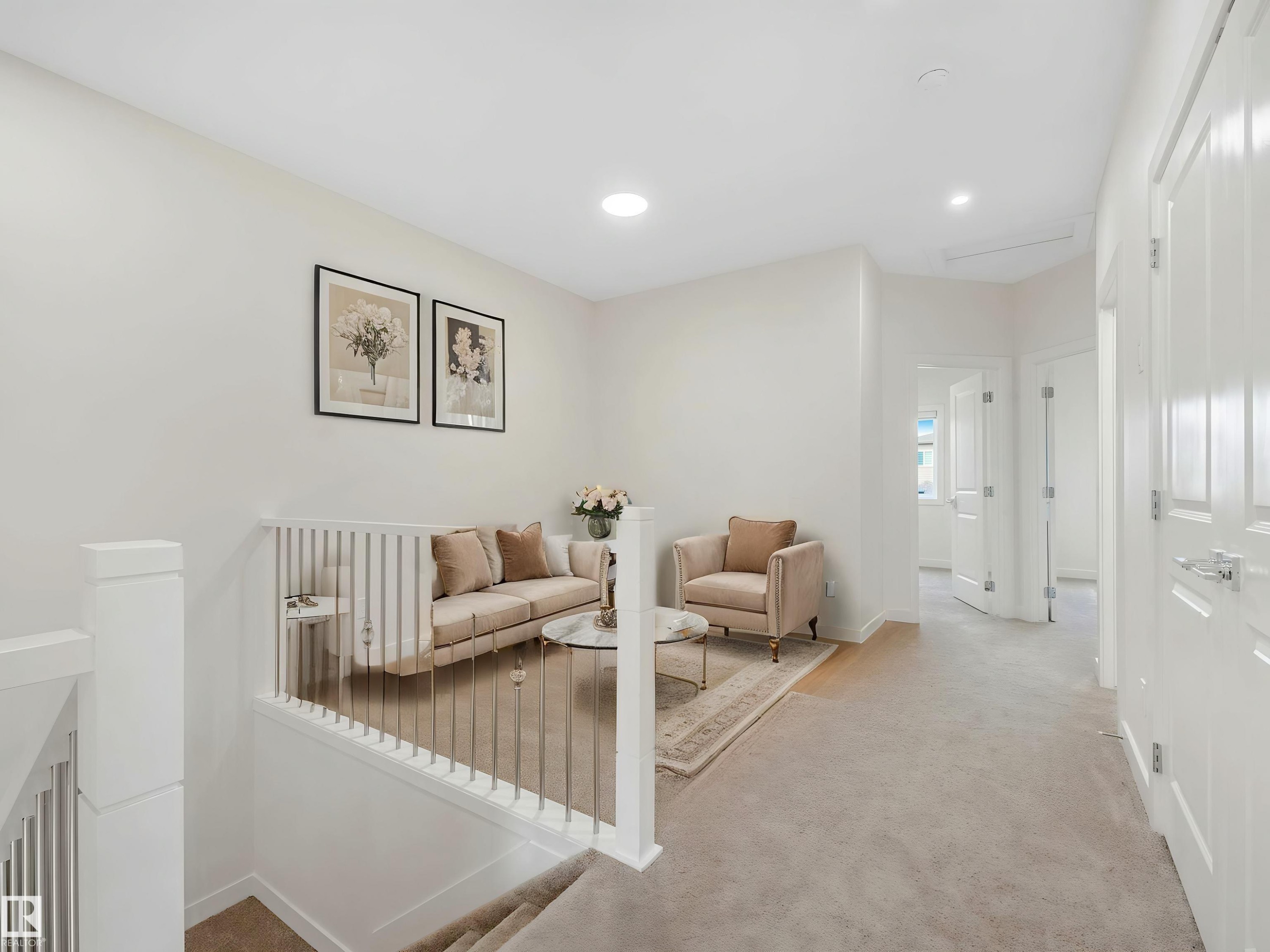 Upper-level landing featuring a white railing with vertical balusters, light-colored carpeting, and recessed lighting - 1518 Siskin Link Link, Edmonton, AB - Indoor Photo Showing Other Room