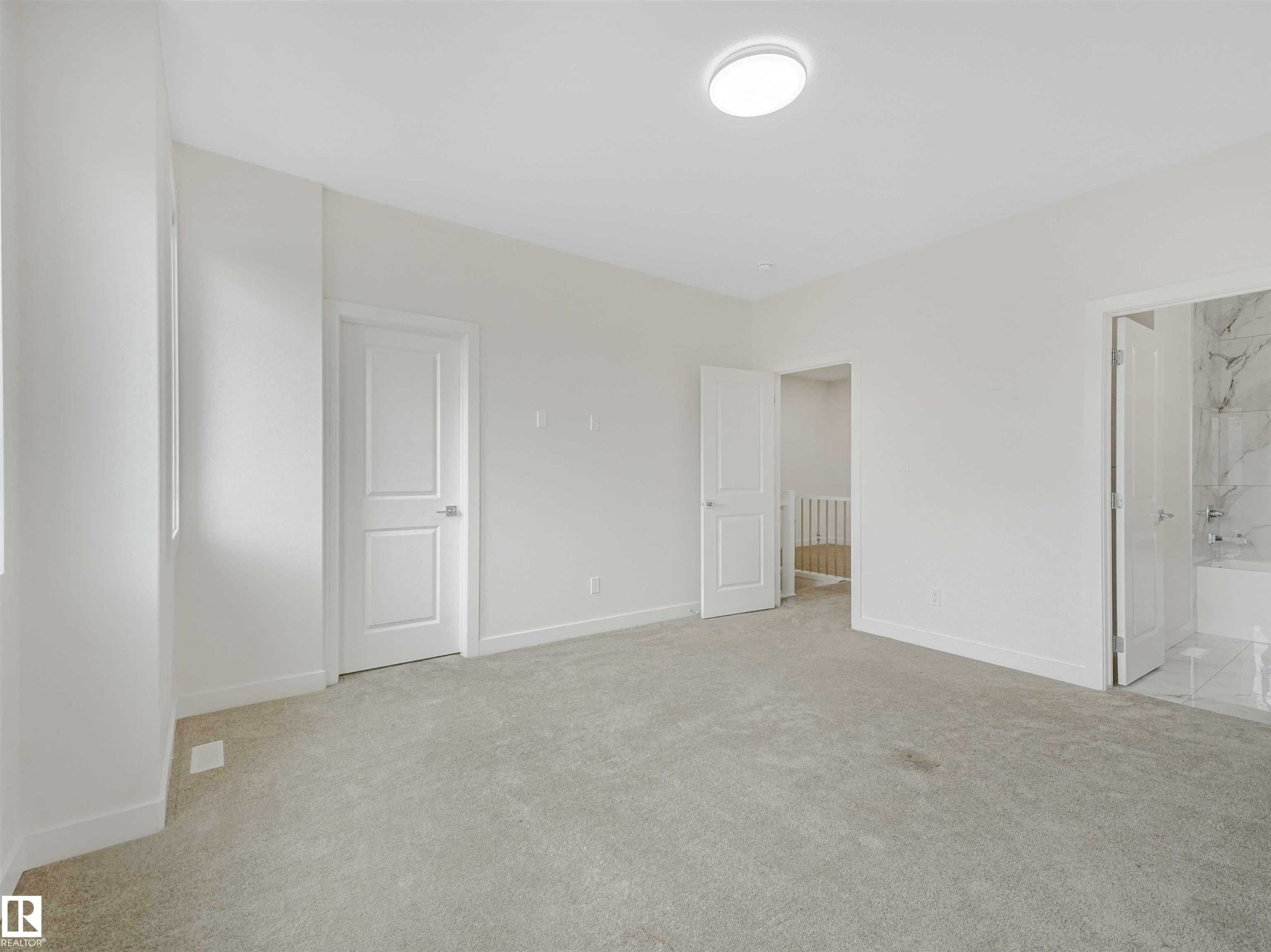 Spacious room featuring light gray carpet flooring, white walls, and bright overhead lighting - 1518 Siskin Link Link, Edmonton, AB - Indoor Photo Showing Other Room