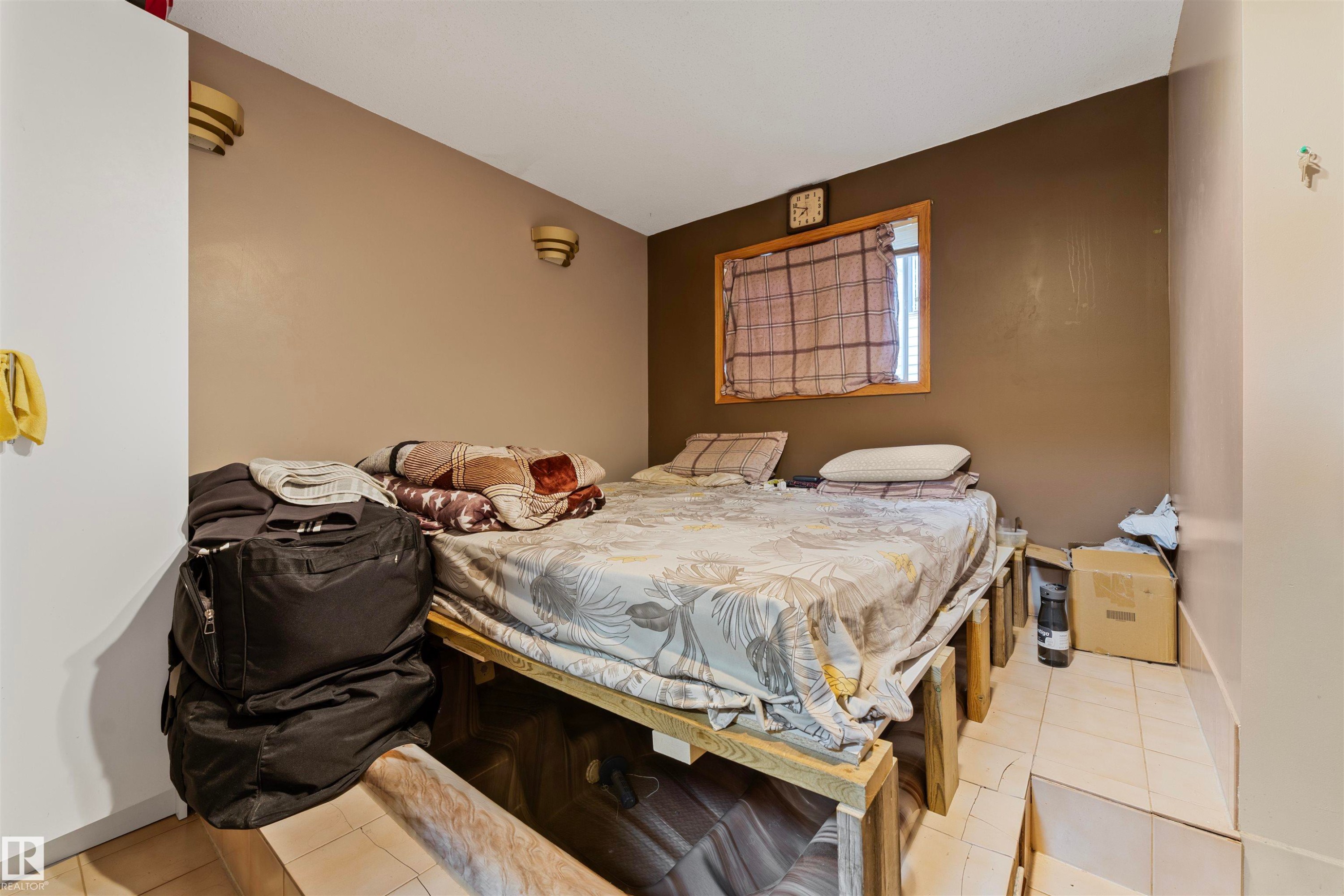 Room featuring a window with a wood frame, light tan wall, and recessed wall sconces - 4231 32 Avenue, Edmonton, AB - Indoor Photo Showing Bedroom