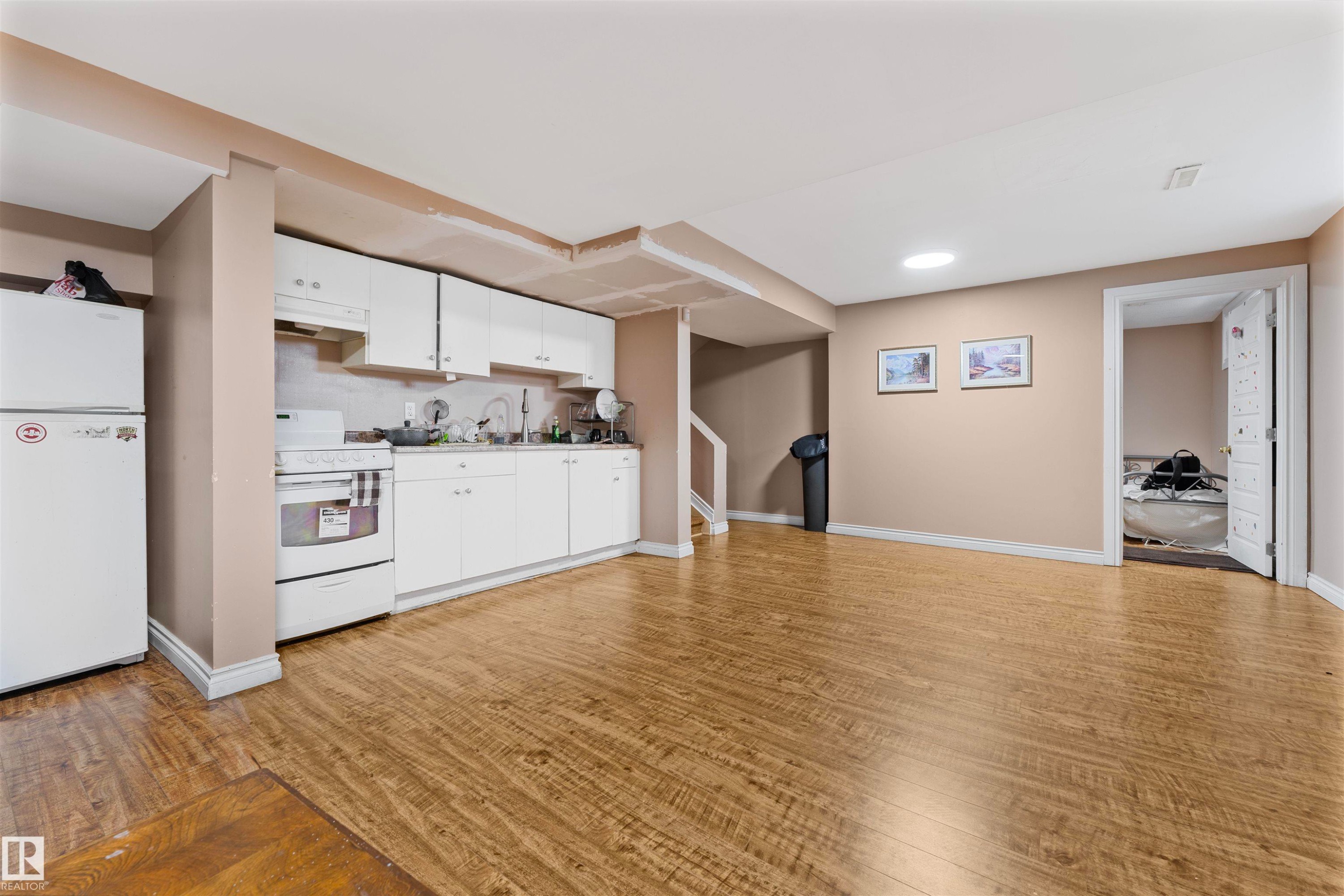 Open-concept living area with wood-finish flooring - 4231 32 Avenue, Edmonton, AB - Indoor