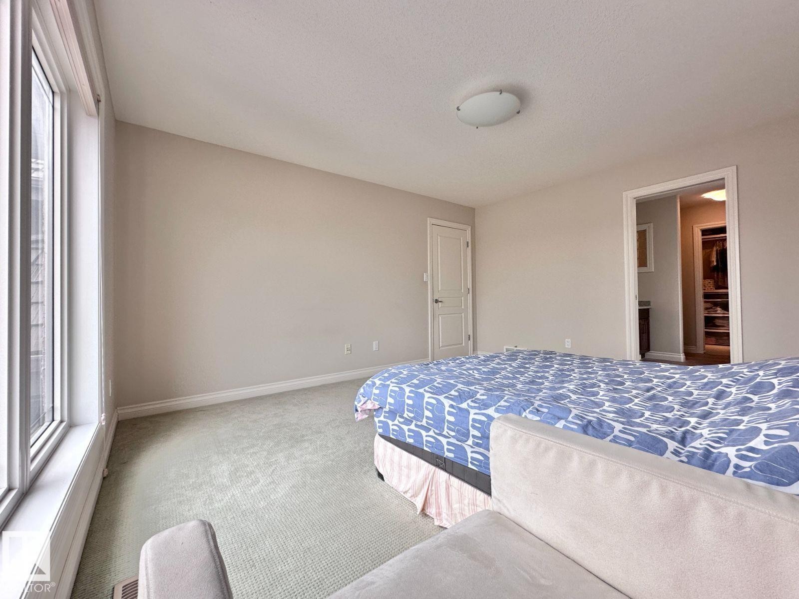 Wall-to-wall carpeting and neutral wall tones - 820 Drysdale Run, Edmonton, AB - Indoor Photo Showing Bedroom