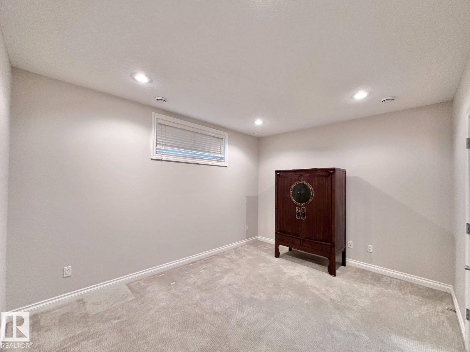 Light gray wall paint complemented by white trim and carpeting - 820 Drysdale Run, Edmonton, AB - Indoor Photo Showing Basement