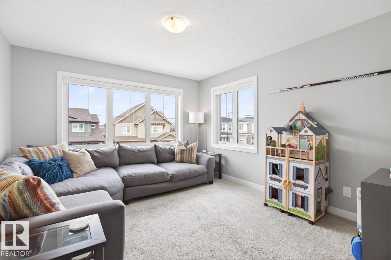 Large Bonus Room Space on the Upper Level featuring Large North West Facing Windows. Great for Movie Nights, Play Time, or add a door and create a 4th Upstairs Bedroom! - 20023 17A Avenue, Edmonton, AB - Indoor Photo Showing Living Room