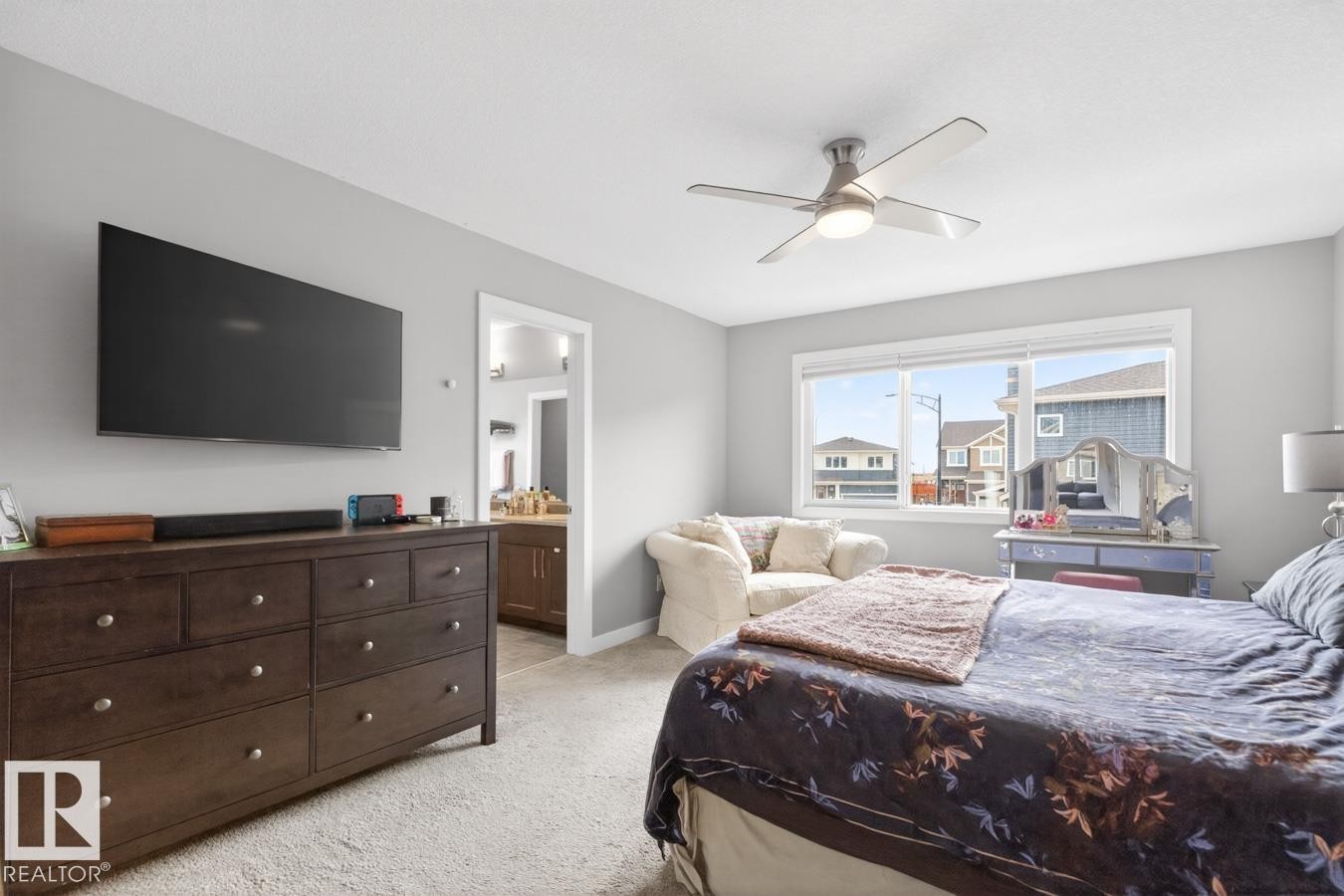 Primary Bedroom with Large South East Facing Windows, Blackout Blinds, and Enough Space to Fit a King Size Bed, Multiples Dressers, and Comfortable Lounging Corner. This bedroom is Huge! - 20023 17A Avenue, Edmonton, AB - Indoor Photo Showing Bedroom