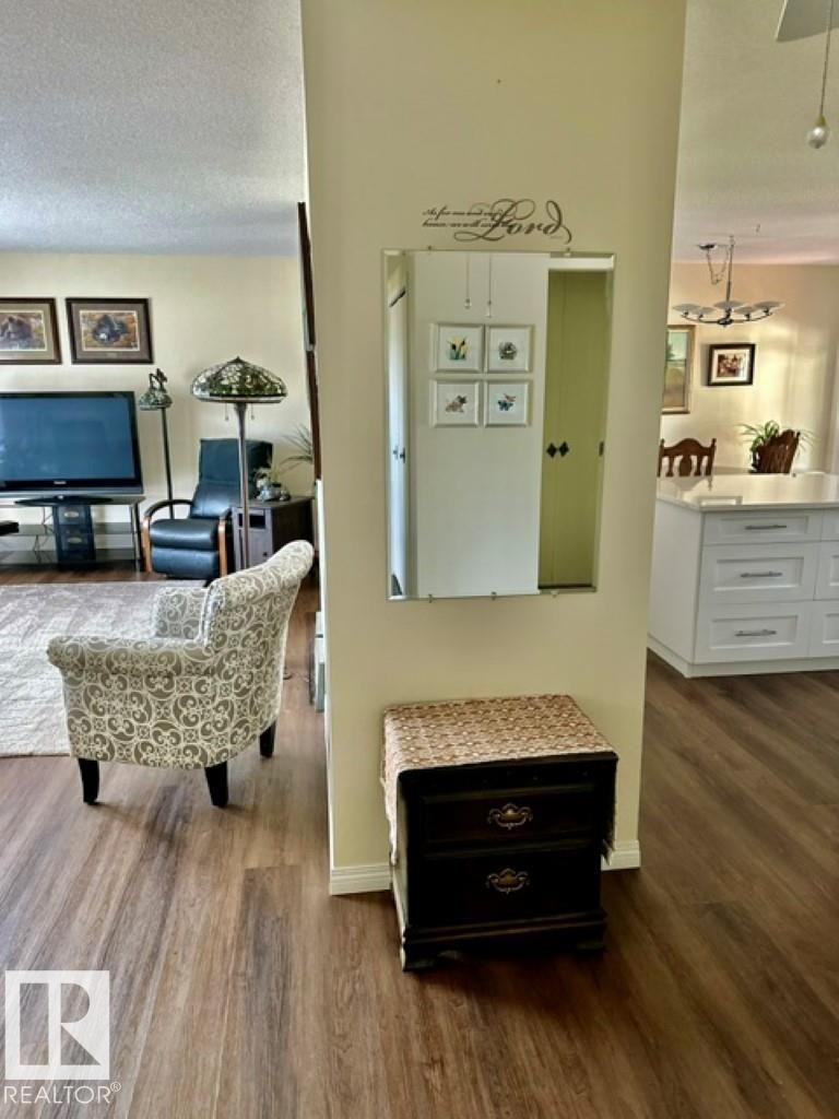 Wood-finish flooring extending throughout the space, with a neutral wall color - 4805 53Ave, Willingdon, AB - Indoor