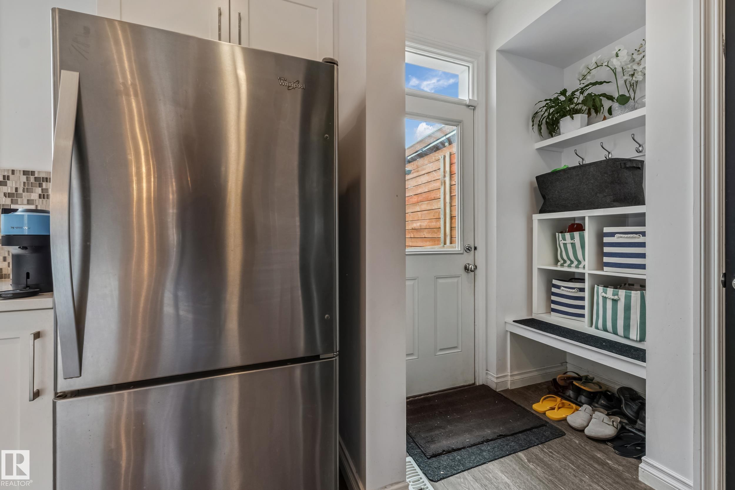 Entryway with built-in storage featuring a bench, shelving, and wall hooks - 8131 Chappelle Way, Edmonton, AB - Indoor
