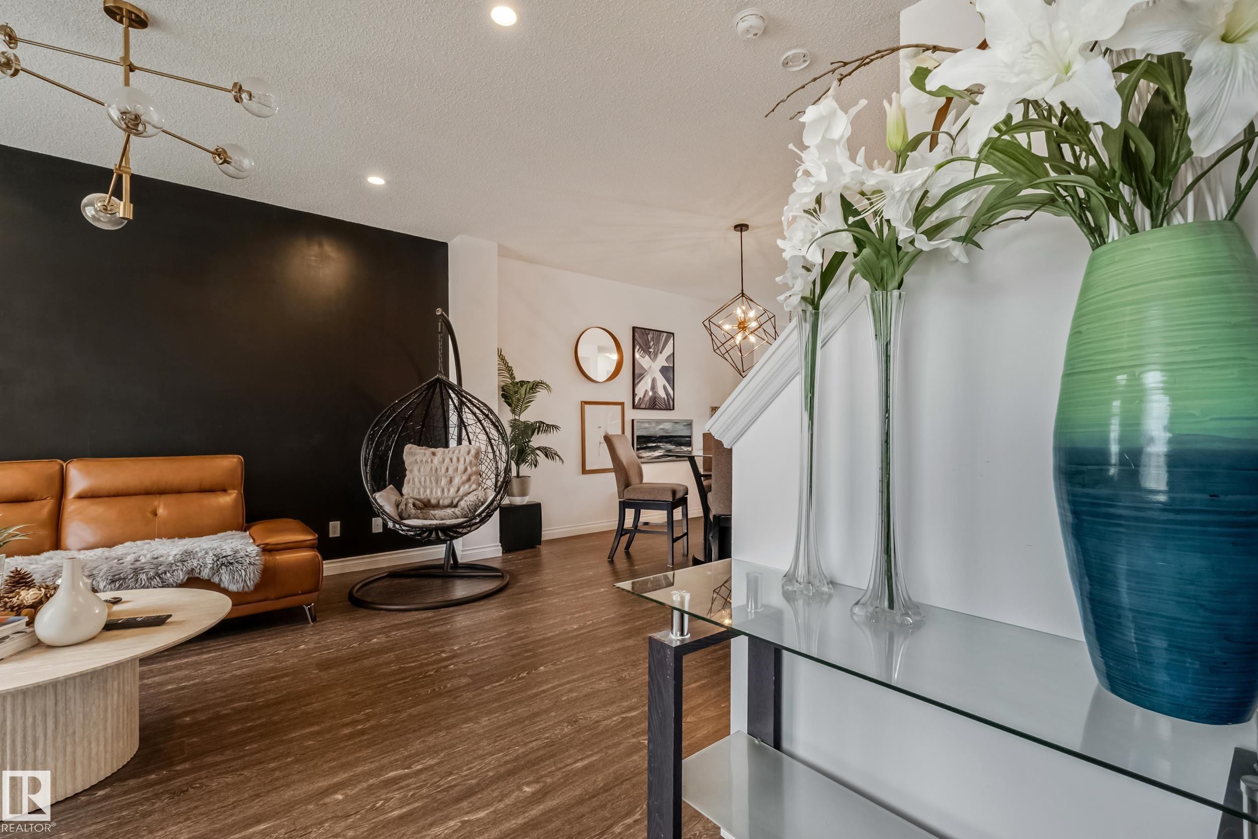 Open-concept living area featuring wood-finish flooring and recessed lighting - 8131 Chappelle Way, Edmonton, AB - Indoor Photo Showing Other Room