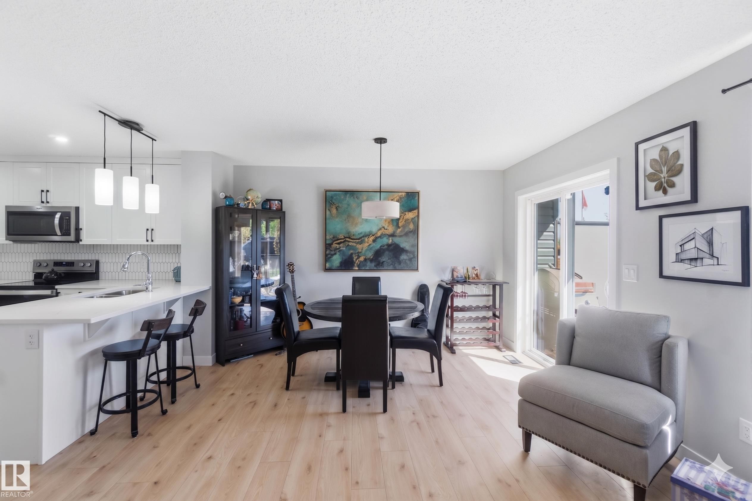 Open-concept living area with light wood-finish flooring - 5129 Lark Crescent, Edmonton, AB - Indoor