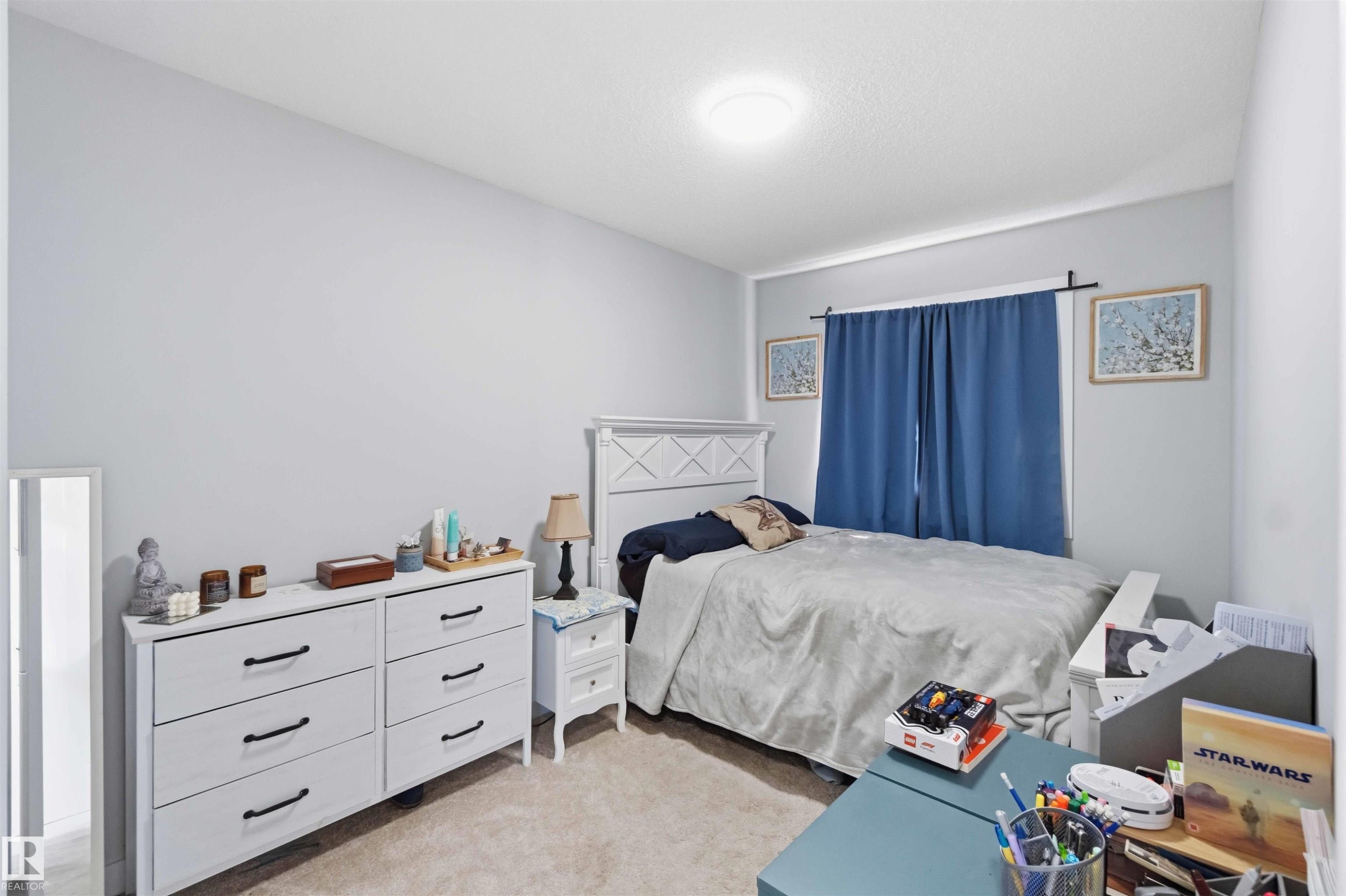 Carpeted room with light gray walls and a flush-mount ceiling light fixture - 5129 Lark Crescent, Edmonton, AB - Indoor Photo Showing Bedroom