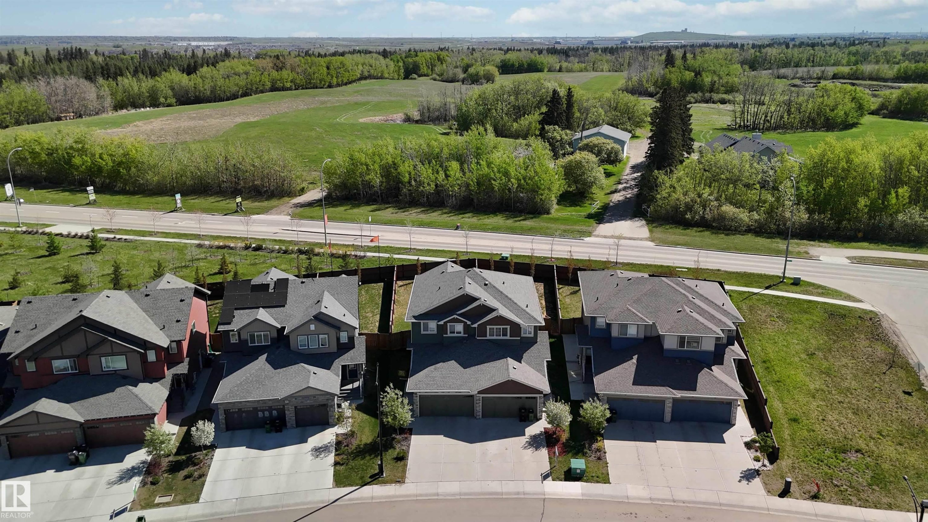 Residential property featuring an asphalt shingle roof, attached garage, and concrete driveway - 5129 Lark Crescent, Edmonton, AB - Outdoor With Facade