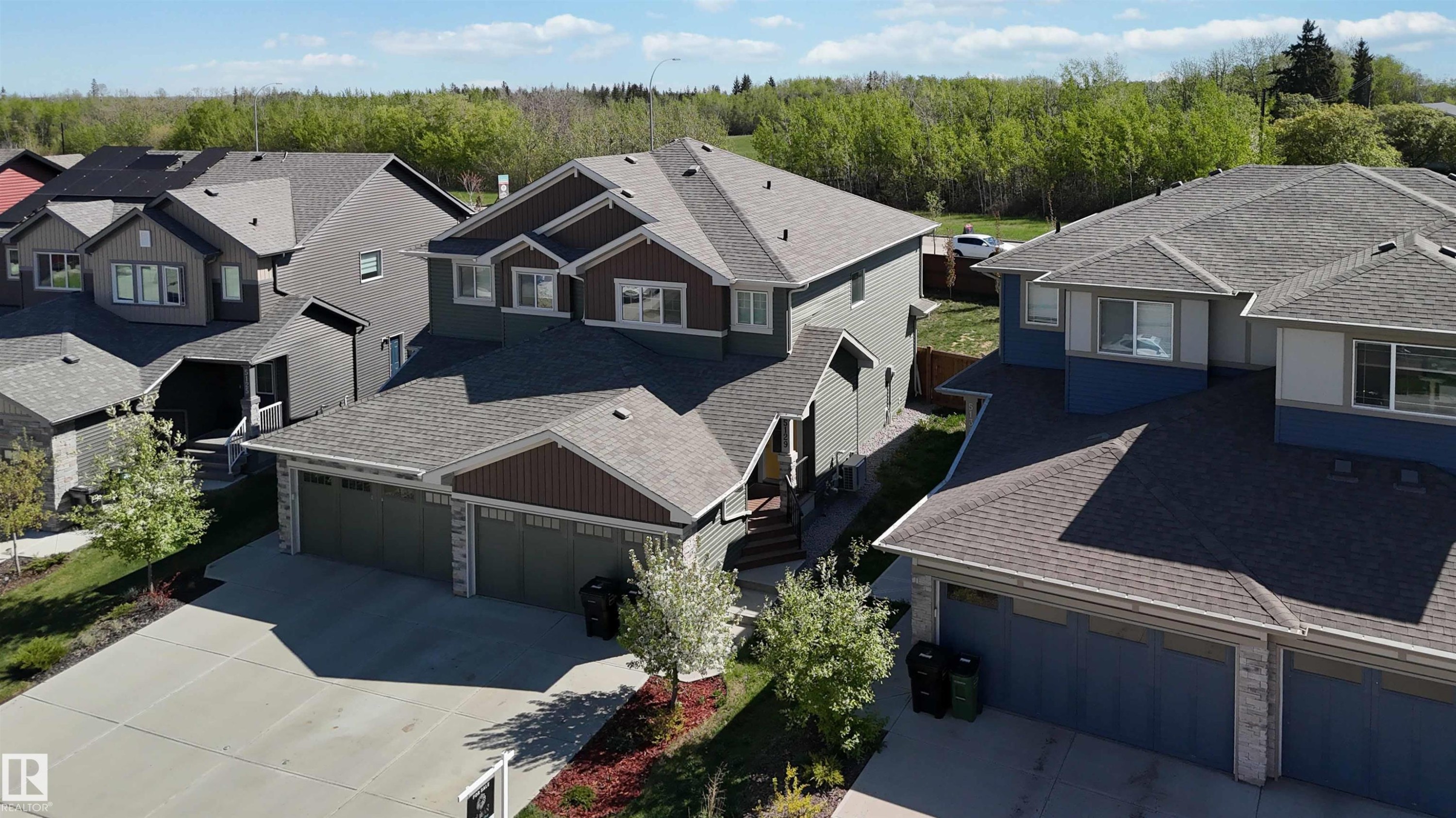 Two-story residence featuring a multi-gable roofline, attached two-car garage, and a concrete driveway - 5129 Lark Crescent, Edmonton, AB - Outdoor With Facade