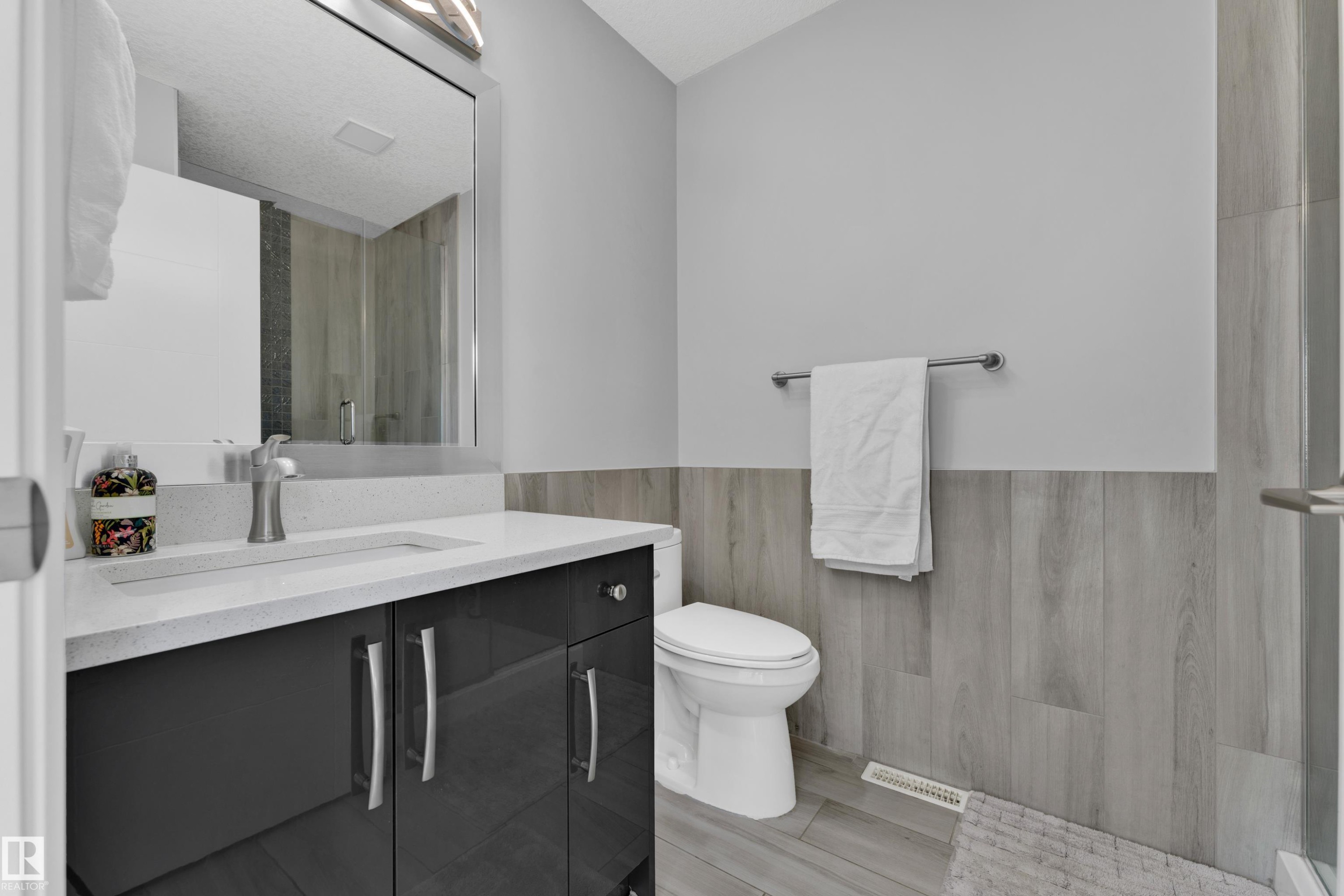 Vanity with a light-colored countertop and under-mount sink - 9329 Connors Road, Edmonton, AB - Indoor Photo Showing Bathroom