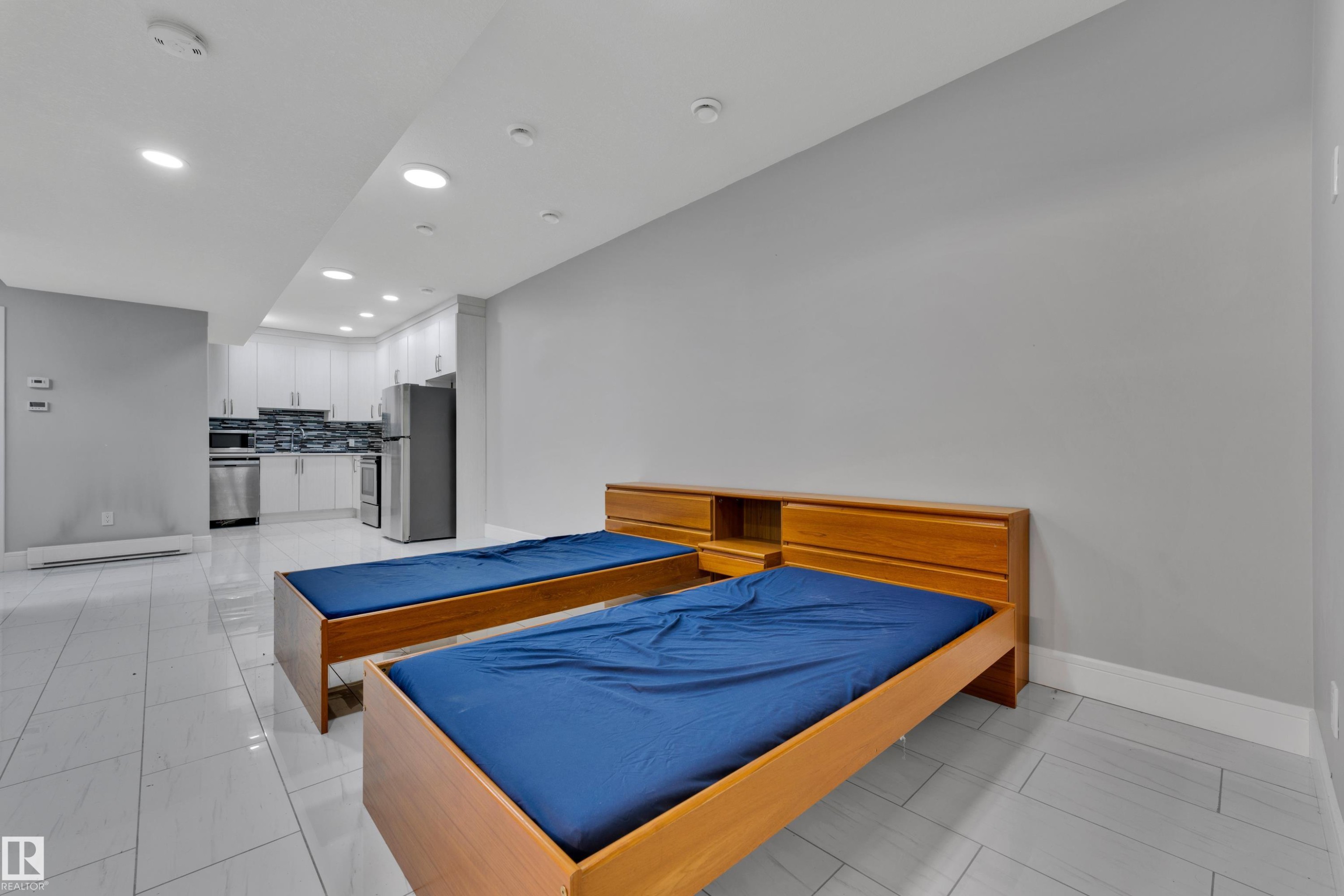 Open-concept living space with light gray walls and white trim - 9329 Connors Road, Edmonton, AB - Indoor Photo Showing Other Room